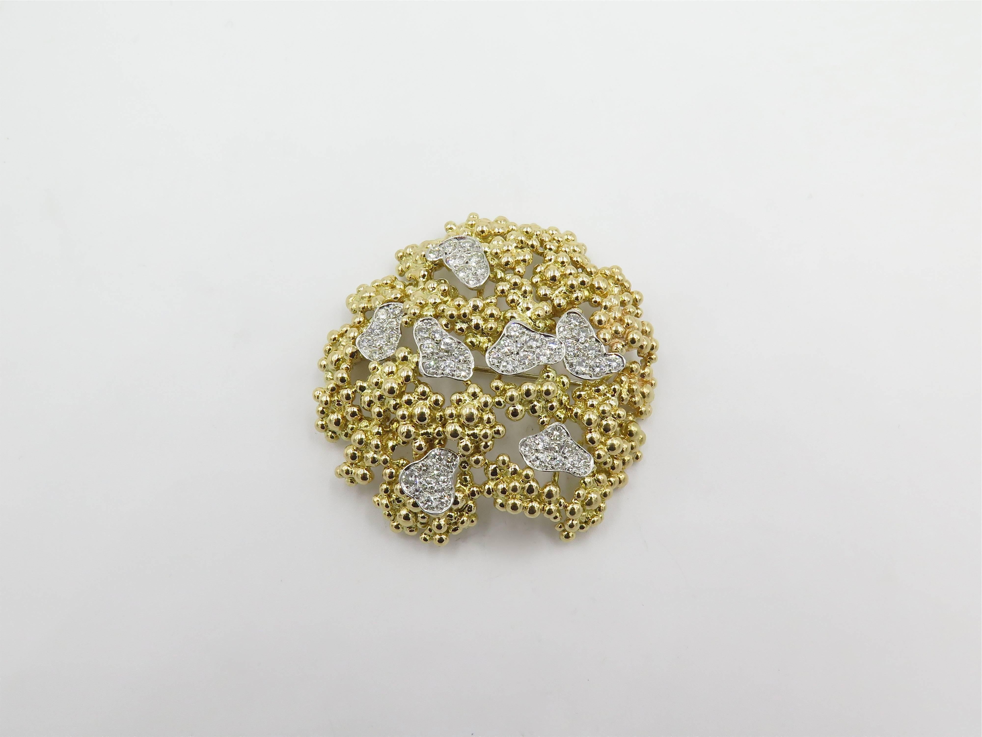 An 18 karat yellow gold, platinum and diamond brooch and earring set. Marian Ostier. Circa 1960. The brooch of free form openwork beaded design, enhanced by pave set diamond panels, and a pair of earrings en suite. The brooch is set with fifty eight