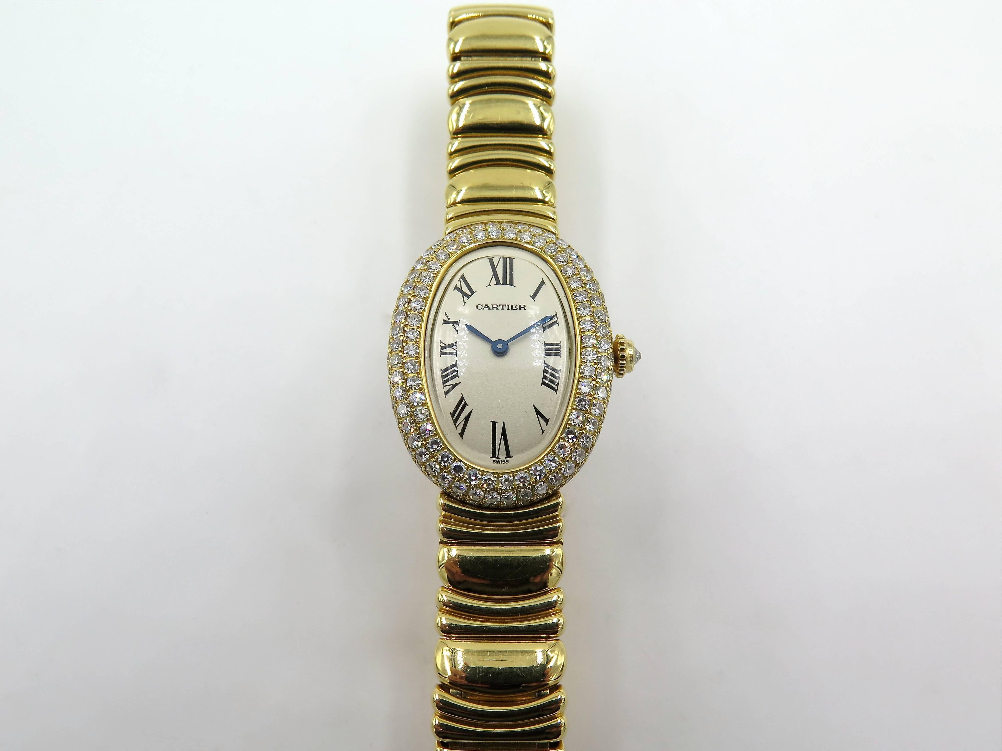 An 18 karat yellow gold ladies Cartier and diamond watch.  Baignoire model.  Serial number 29158057912. Of quartz movement, the white oval dial with black Roman numerals and blued steel hands, secret signature at 10 o'clock, with pave set diamond