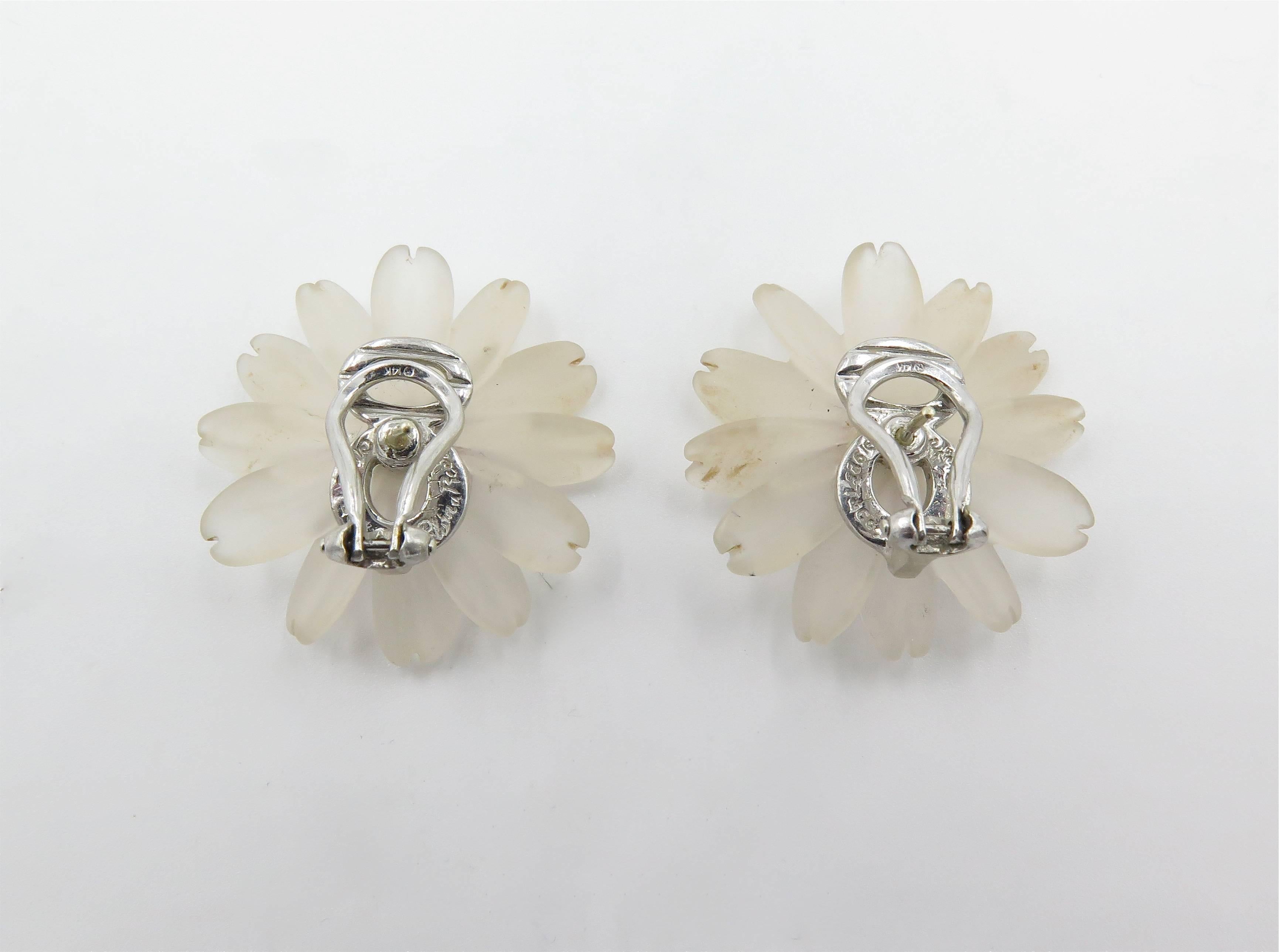 A pair of 14 karat white gold, frosted rock crystal and pink tourmaline flower earrings. Paloma Picasso, Tiffany & Co. 1983. Each designed as a carved frosted rock crystal flower head, centering a triangular cut tourmaline sapphire. Diameter is