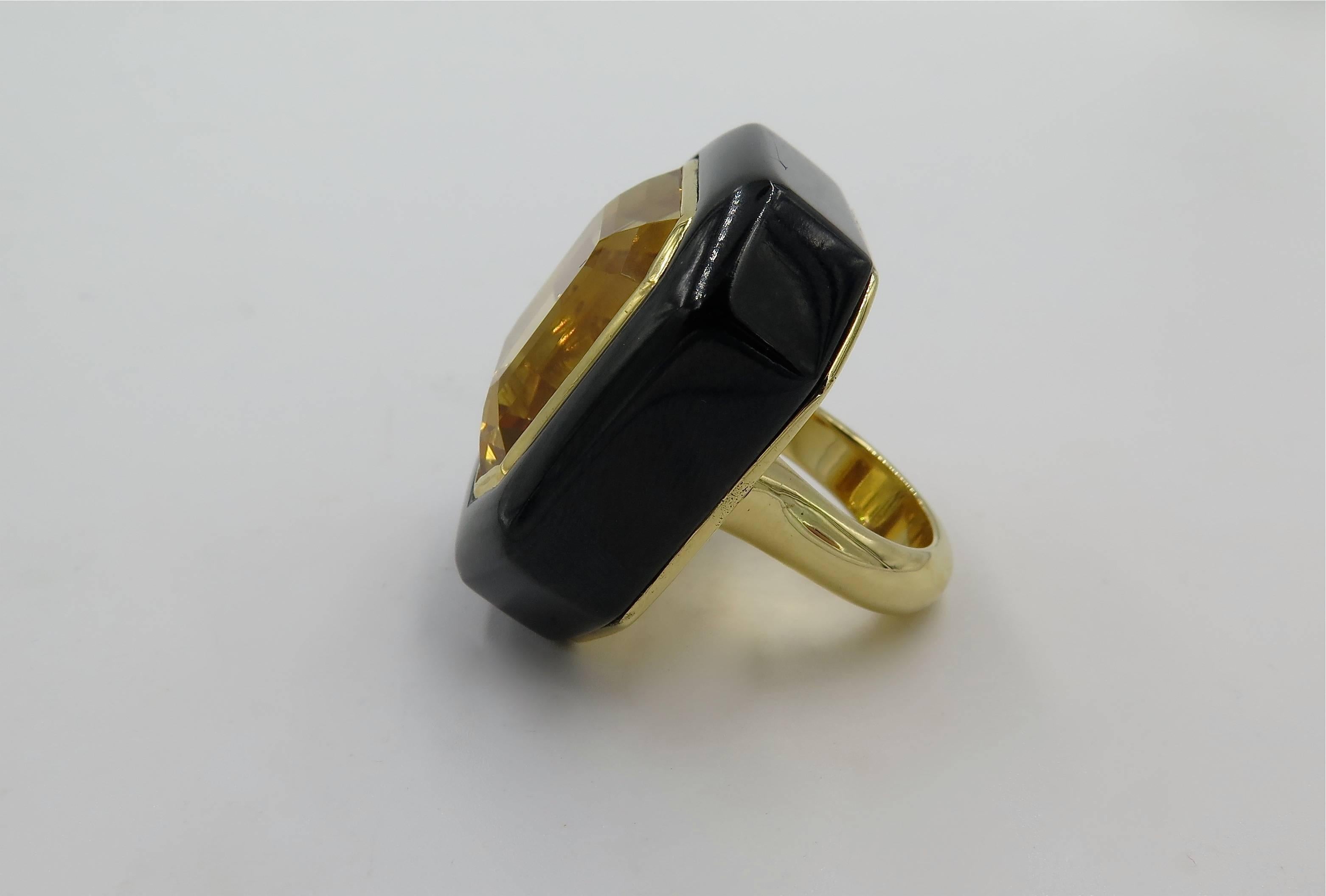An 18 karat yellow gold, citrine and black jade ring. Centering an emerald cut citrine, weighing 45.49 carats within a black jade bezel, with polished gold shank. Size 6. Gross weight is approximately 51.9 grams. Designed by Marcella Ciceri. 