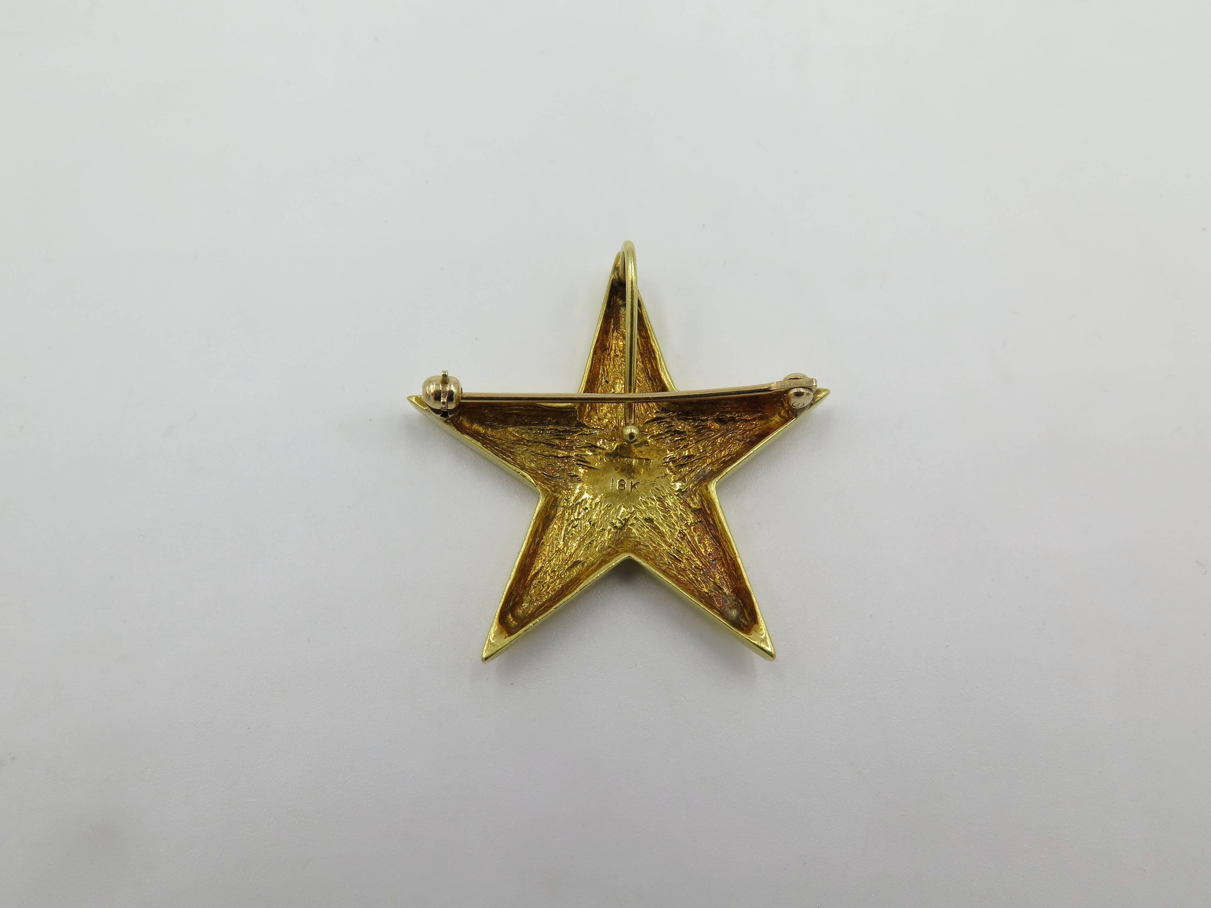 An 18 karat yellow gold star pendant brooch. Cartier. Circa 1970. Of polished gold design. Length is approximately 1 1/2 inches. Gross weight is approximately 7.8 grams. 