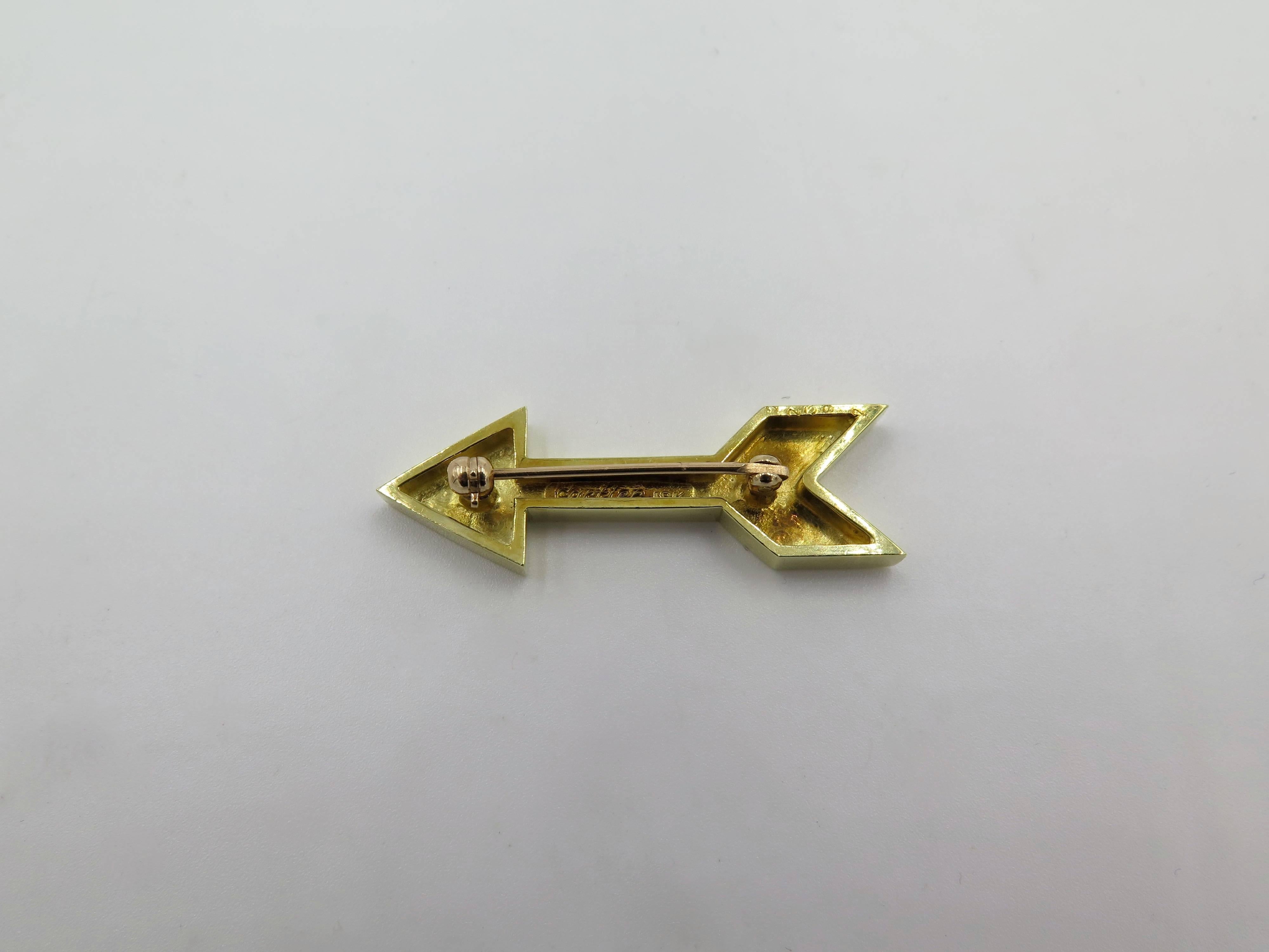 An 18 karat yellow gold arrow brooch. Cartier. Circa 1970. Of polished gold design. Length is approximately 1 1/2 inches.  Gross weight is approximately 8.3 grams. Stamped Cartier, 18K, numbered 22392.