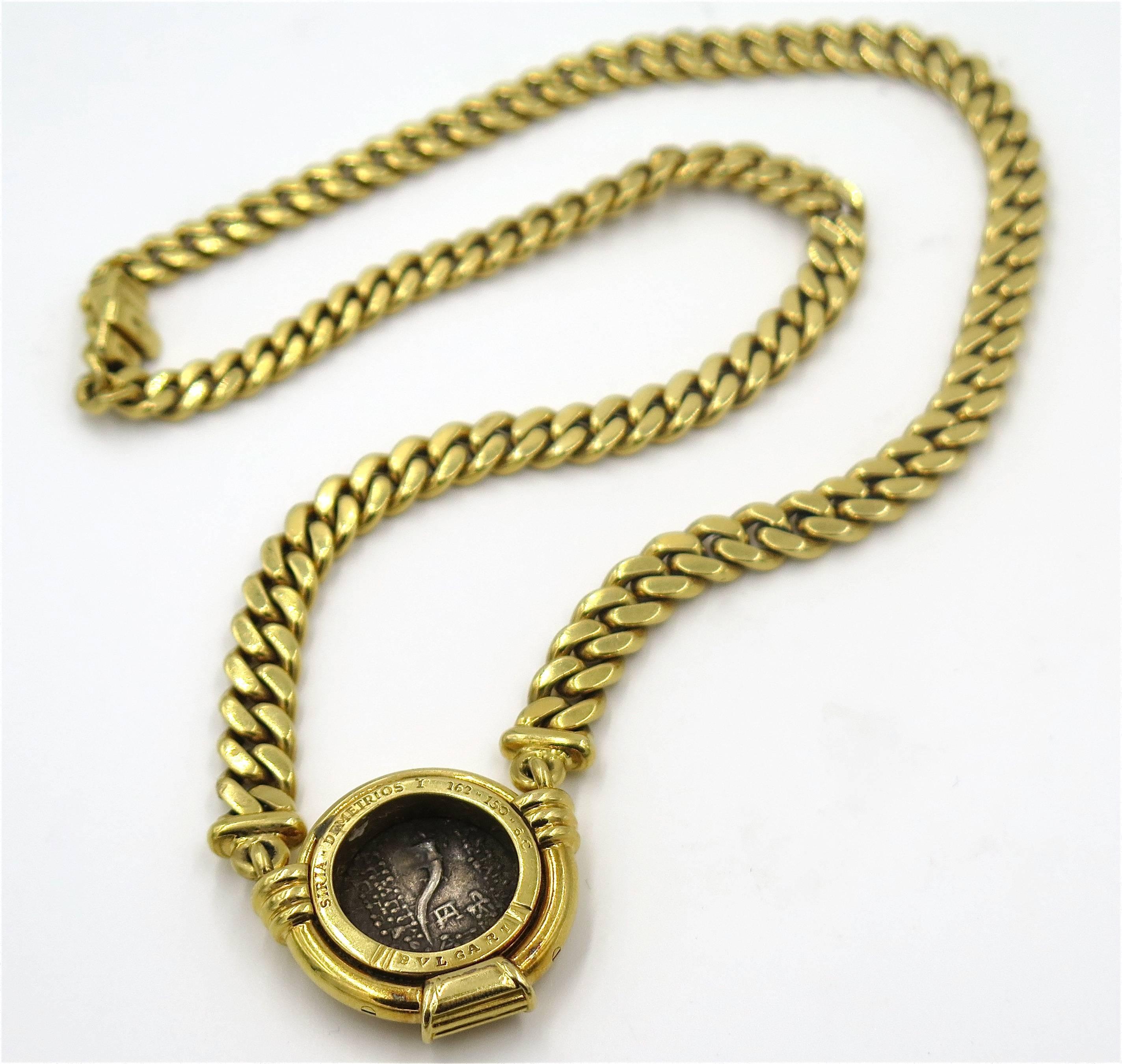 An 18 karat yellow gold and “Siria-Demitrios I 162-150 C.E.” ancient coin necklace, Bulgari.  The coin is bezel set in a yellow gold frame with fluted accents and is suspended from a graduated curb link chain.  The necklace has a gross weight of