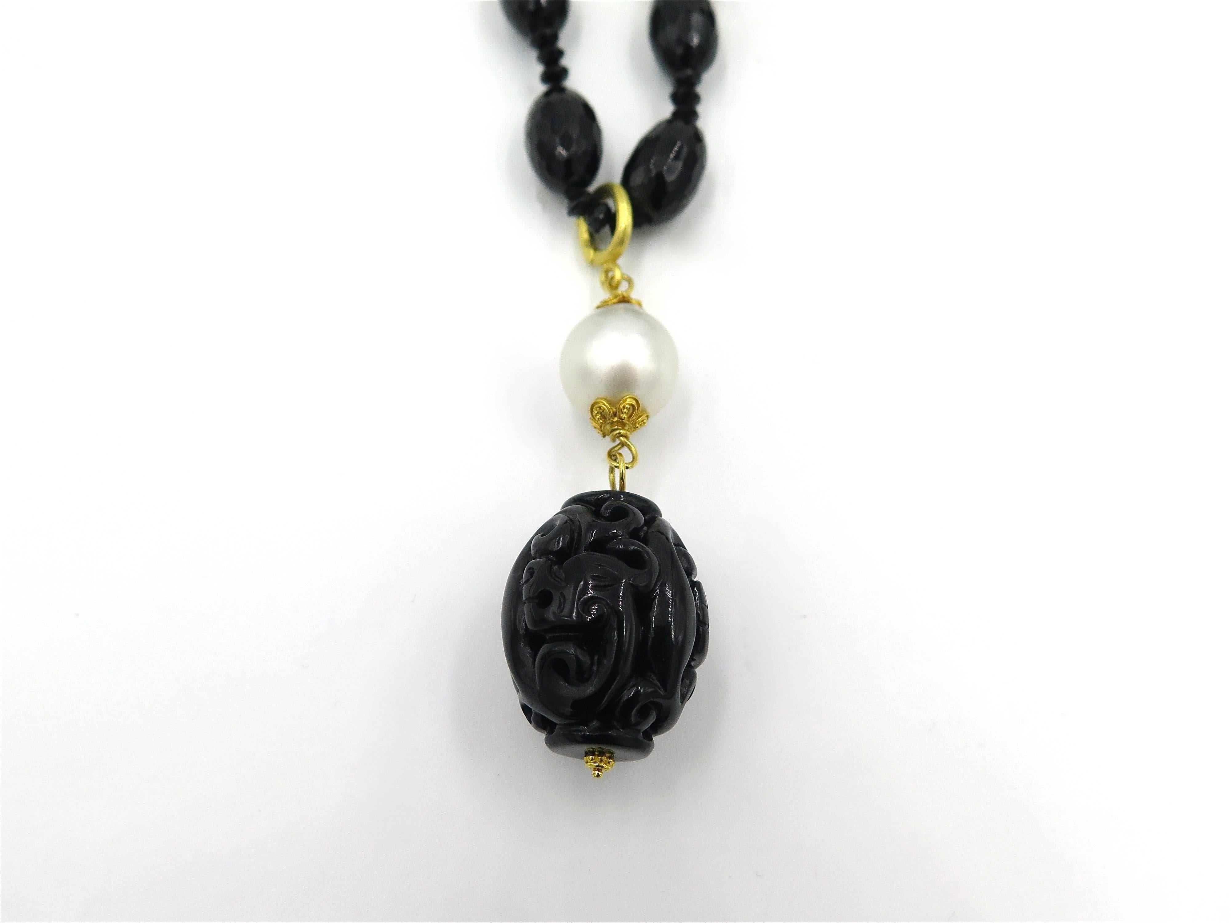 An 18 karat yellow gold, faceted and carved black onyx bead and baroque pearl necklace with detachable pendant, Verdura. The pearls measure approximately 10.00 to 14.00 mm.  The necklace has a gross weight of approximately 134.6 grams and measures