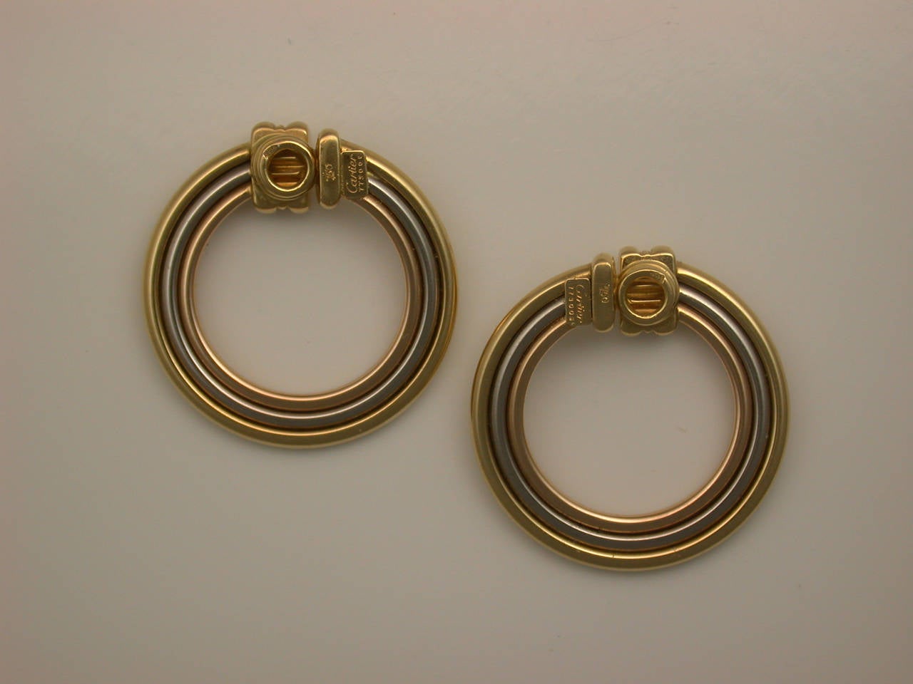 Elegant in their simplicity, designed as concentric circles of polished yellow, white and rose gold, with ribbed detailing at the top, they pull apart gently with a spring mechanism and close back onto the ear lobe, a short post could be added for