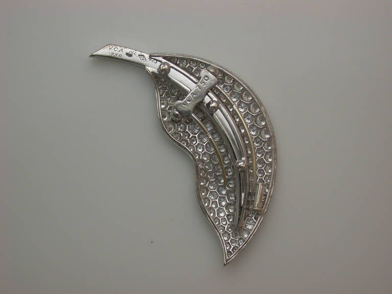 The scrolling leaf brooch set with approximately 4 1/2 carats total weight gem white diamonds, mounted in 18kt white gold, with hinged double-pin clip back and safety catch, signed VCA for Van Cleef & Arpels, stamped 750, Van Cleef maker's mark and