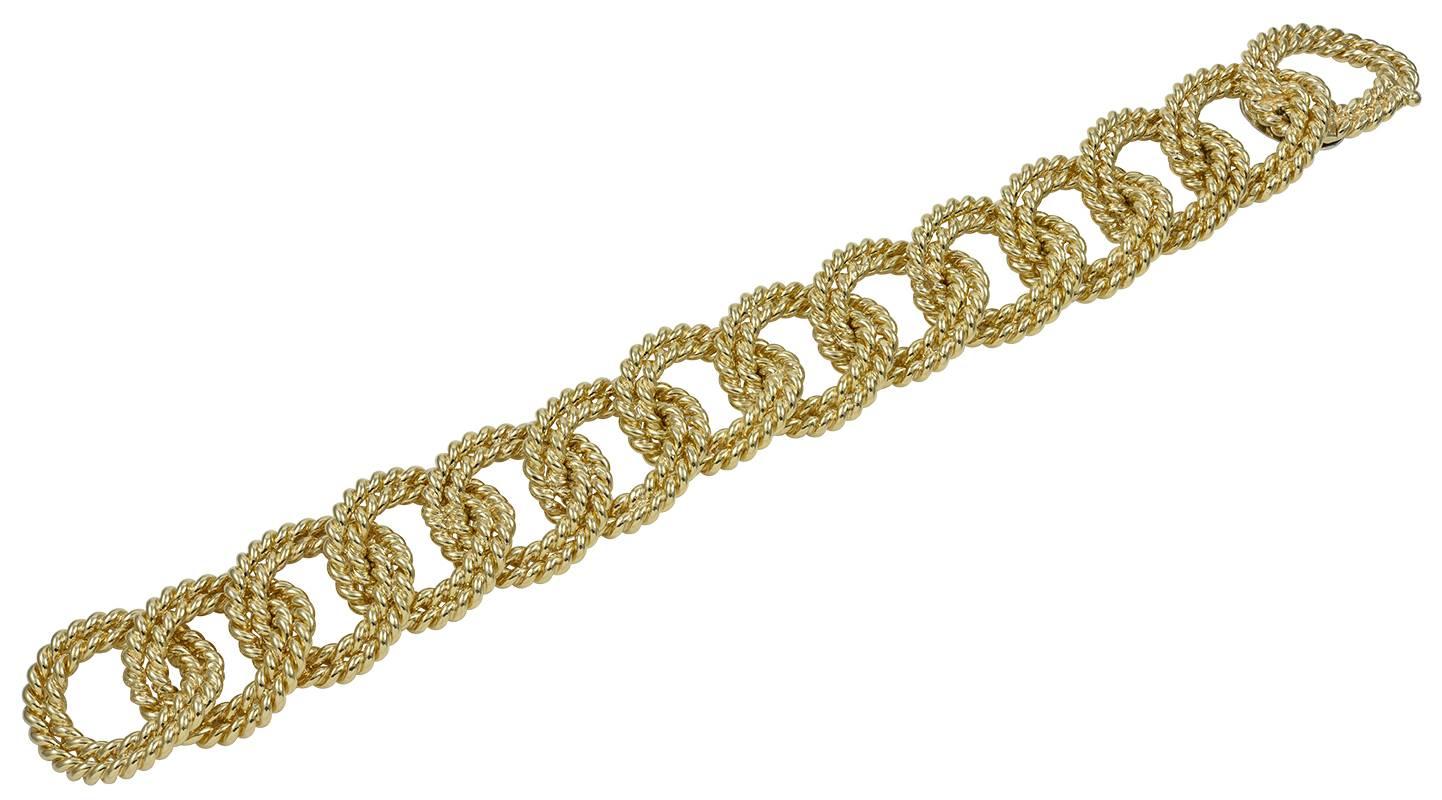 A Verdura classic, the rope-link bracelet in 18kt yellow gold, designed as a flexible row of 14 curbed double rope links, with integral clasp, measuring approximately 8 1/2 inches long by 3/4 inch wide, weighing approximately 84.8 dwt or 131.4
