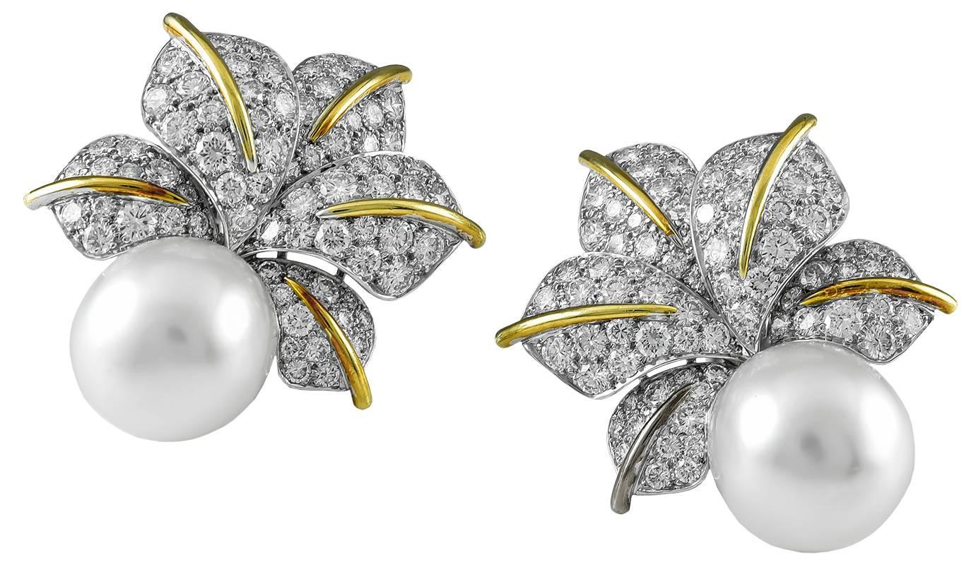 White 13mm South Sea cultured pearls crowned with sprays of five dimensional diamond-set leaves mounted in platinum (approximately 5 1/2 carats total weight), enhanced down the centers with polished 18kt yellow gold stems, large and showy, measuring