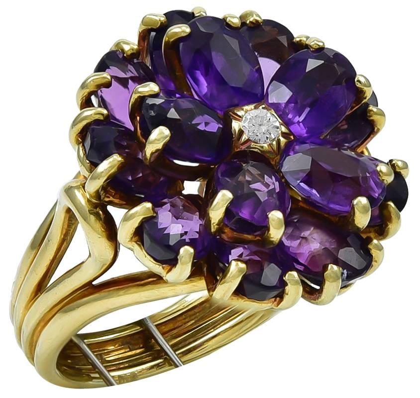 An elegant Retro period brooch and ring set, each featuring an attractive flower head set with faceted oval amethysts around a diamond center, the brooch designed as a bouquet of oak leaves tied with a ribbon bow and set with a diamond accent, the