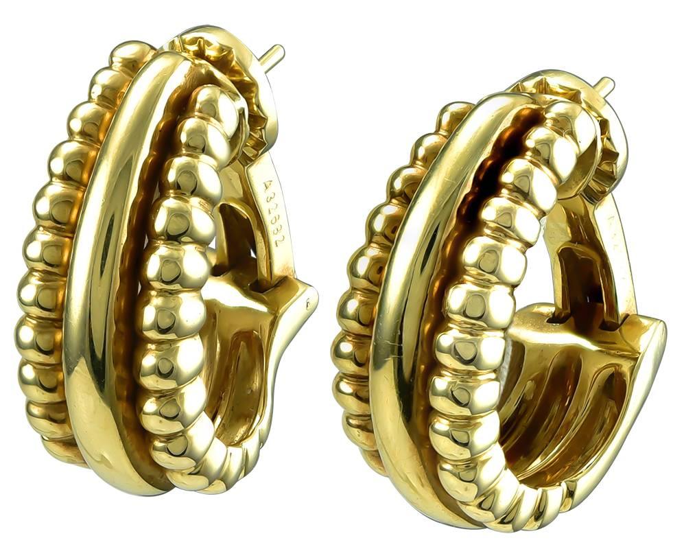 A simple but stylish earring for every day in a flattering half hoop design decorated in three vertical rows at the front (plain polished centers flanked by rows of bead work), sturdy clip backs and posts, signed Piaget (retailed by the Swiss