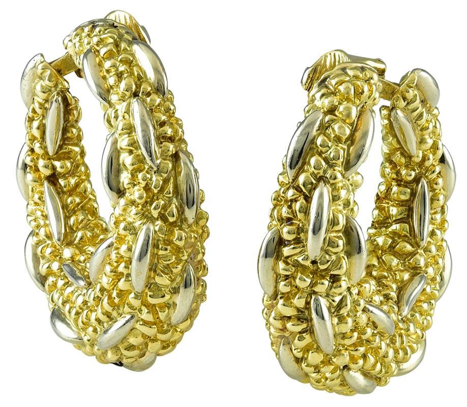 The bold, textured yellow gold hoops with contrasting 