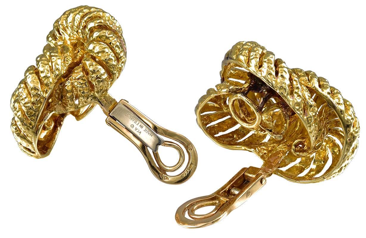The earclips designed as textured yellow gold openwork knots, large in scale with nice dimension on the ear, signed VCA for Van Cleef & Arpels, design copyrighted, Made in France, with French maker's mark for Vassort and French assay marks for 18kt