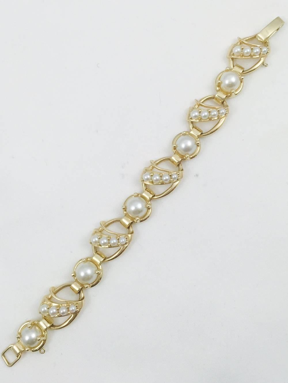 A fantastic bracelet as classic today as it was 50 years ago!  All pearls are beautifully matched for lustre and tint.  Individually prong set with graduated sizes enhancing the open links.  A secure snap down clasp.  Pearls are an essential part of