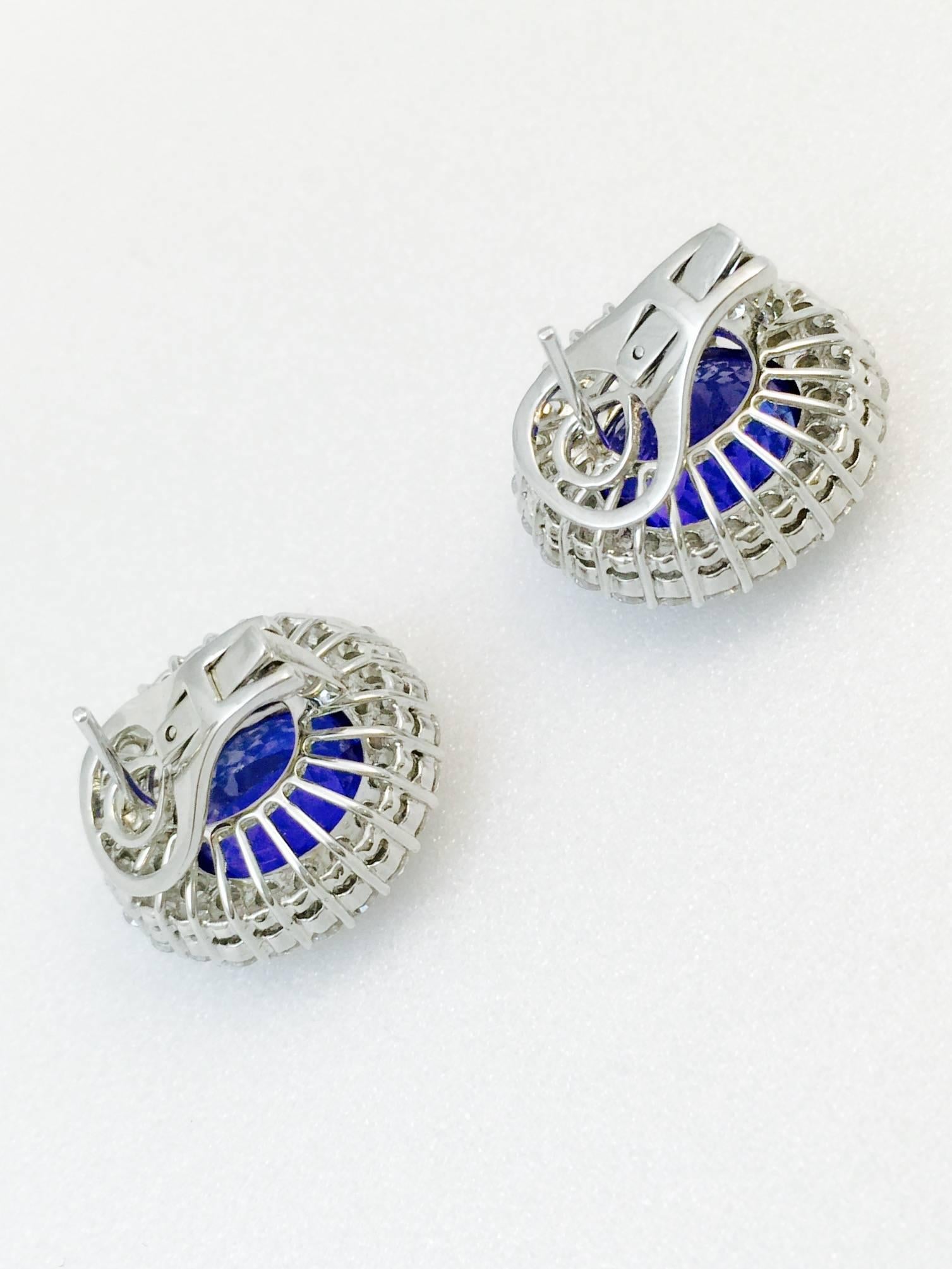 Italian made in 18 karat white gold, these Omega back pierced earrings are nothing short of tremendous!  Beautifully matched tanzanites boast magnificent depth of color with even saturation and have a total weight of 14.90 carats.  Two rows of prong