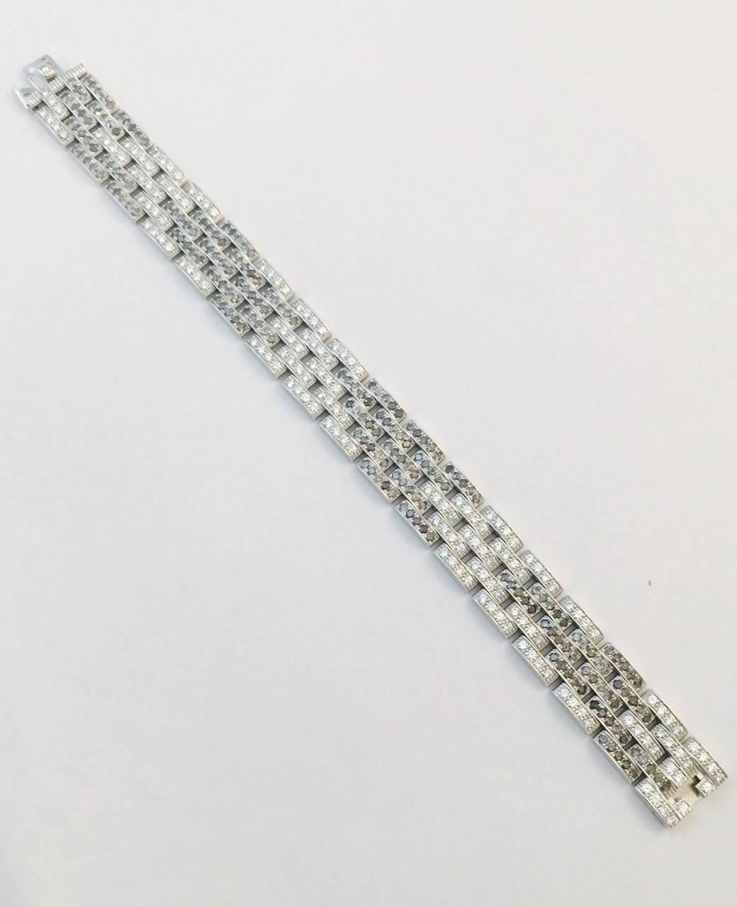 Rarely available with black and white diamonds, this Cartier Maillon Panthere bracelet is highly prized by connoisseurs of fine gems in general and Cartier in particular!  More commonly found with three rows, this 5 row stunner is instantly