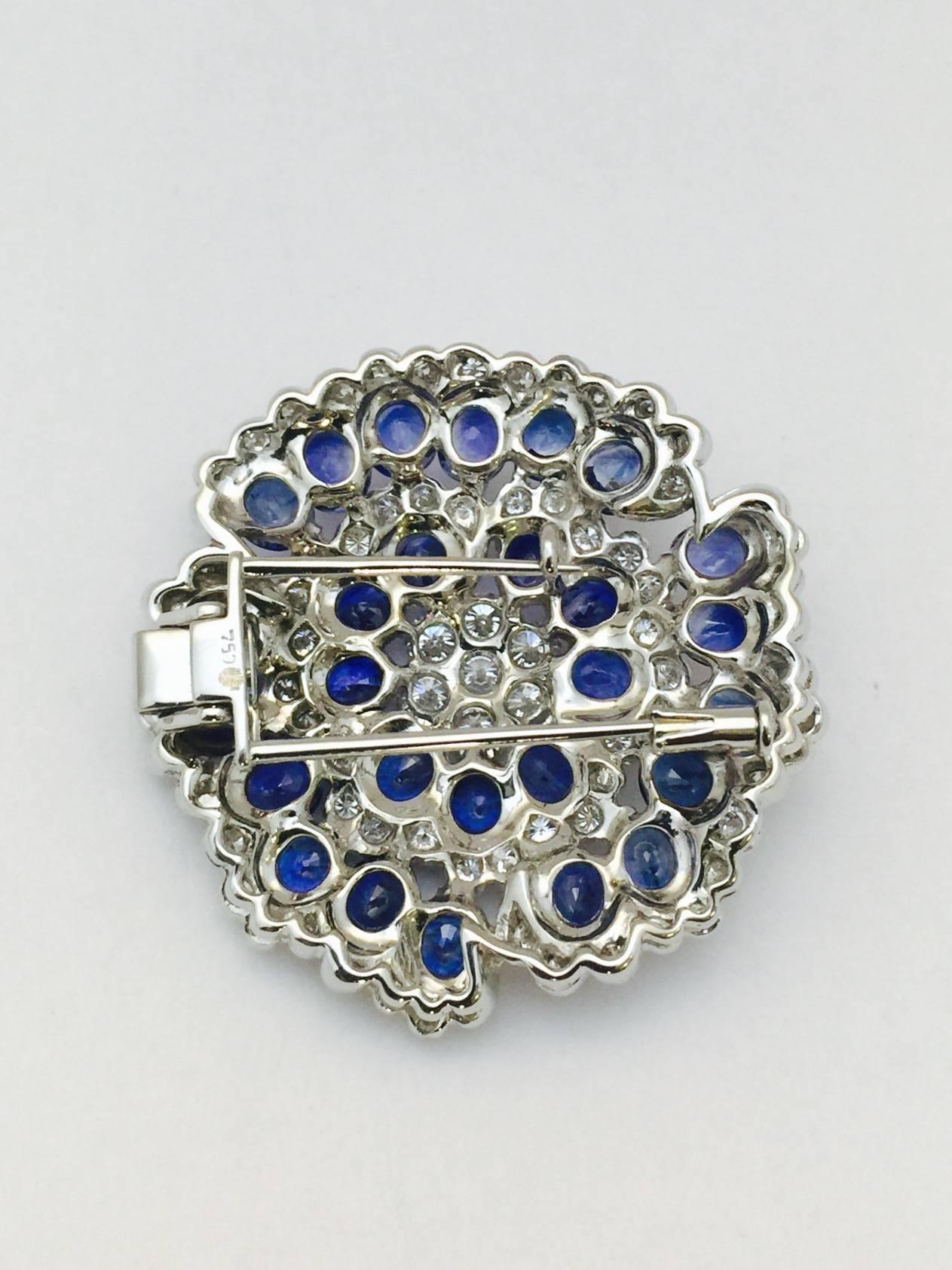  this breathtaking brooch is beyond description.   We present this 1.50" diameter brooch fabricated in 18 karat white gold.  Perfectly matched oval Ceylon sapphires, with a total weight of 16.70 carats, pair beautifully with white brilliant cut