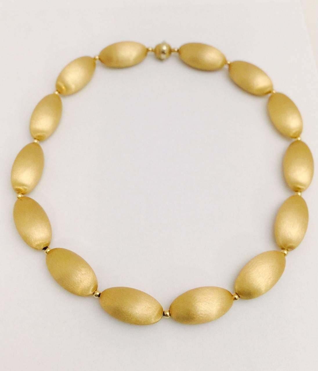 Nothing else feel like real gold is an understatement!  Originally purchased at Neiman Marcus for $9800 this fabulous necklace is 20".  A new kind of modern, minimalistic opulence with subtly textured 18 karat gold.  Oblong matte finish beads