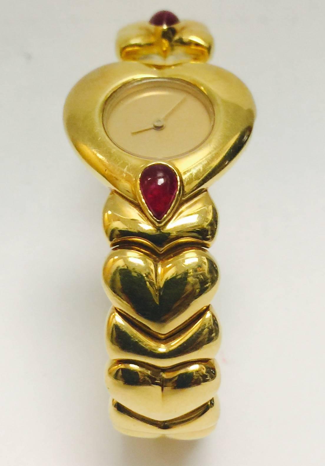 This 18 karat yellow gold watch is a real find!  The heart shape continues all the way around the open ended bracelet. So easy to put on and take off! Two pear shape cabochon rubies add interest and color.  Swiss Quartz movement.  A diamond is