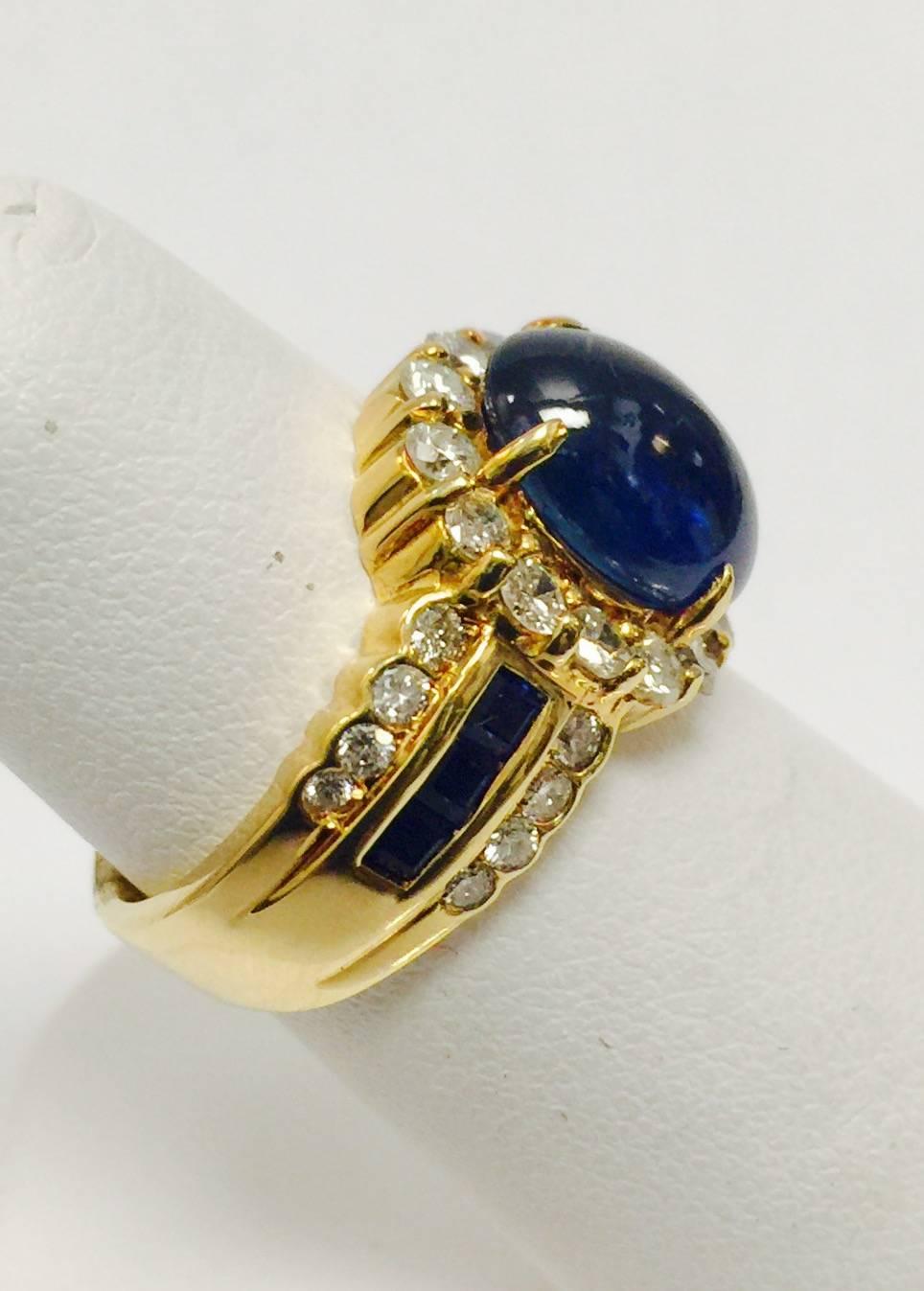 Beautifully crafted in 18 karat yellow gold, this ring is a pure classic!  Featuring a prong set, oval cabochon sapphire weighing 4.60 carats.  Surrounding the sapphire are matched round full cut diamonds that also embrace both sides of the shank