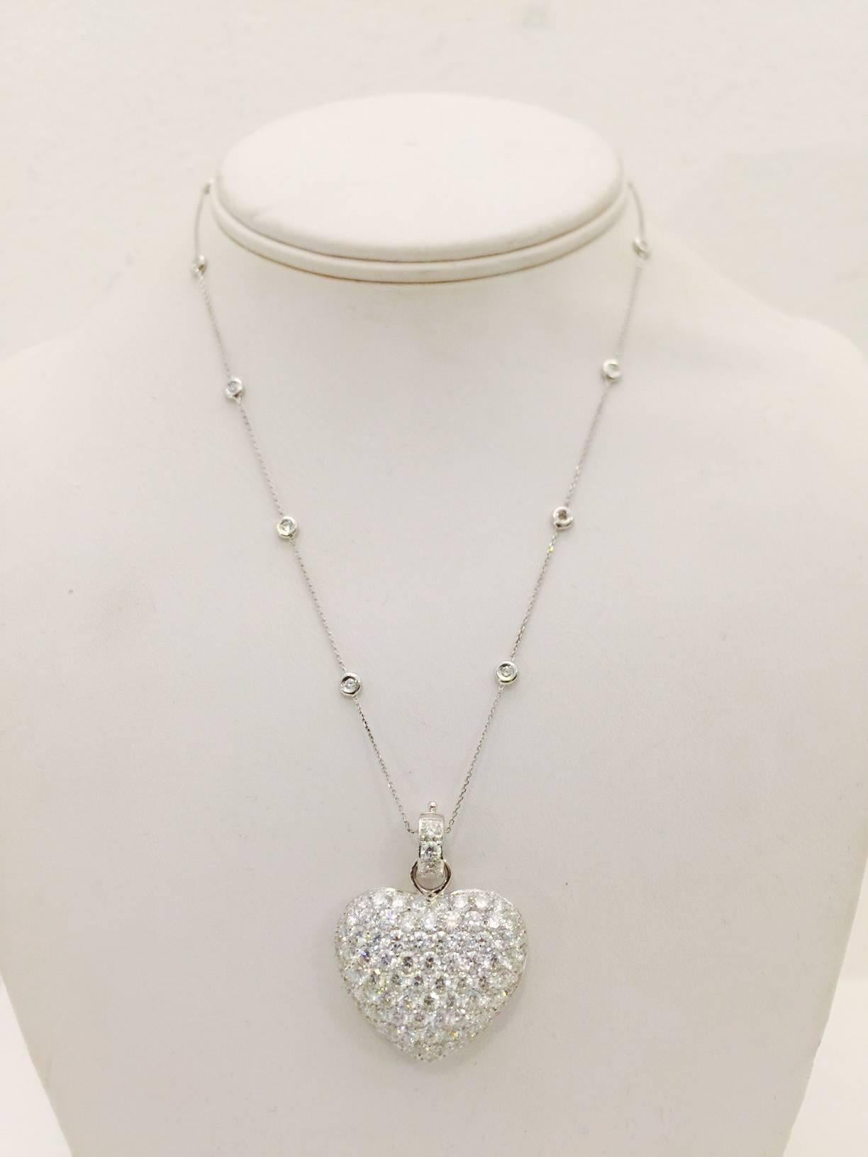 Breathtaking!  Intricately crafted in 18 karat white gold, this necklace has it all!  Beautifully matched round diamonds cover the front and bale with a combined total weight of 8.80 carats.  E color and VVS1 clarity speak for themselves.  The bale