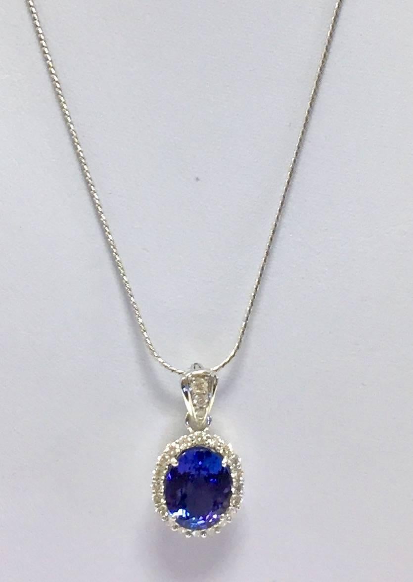 Larger tanzanites are getting harder to find!  This exceptional faceted oval beauty weighs 4.06 carats, surrounded by white brilliant cut diamonds with an additional total weight of .61 carats.  The snap down bale would fit perfectly between pearls!