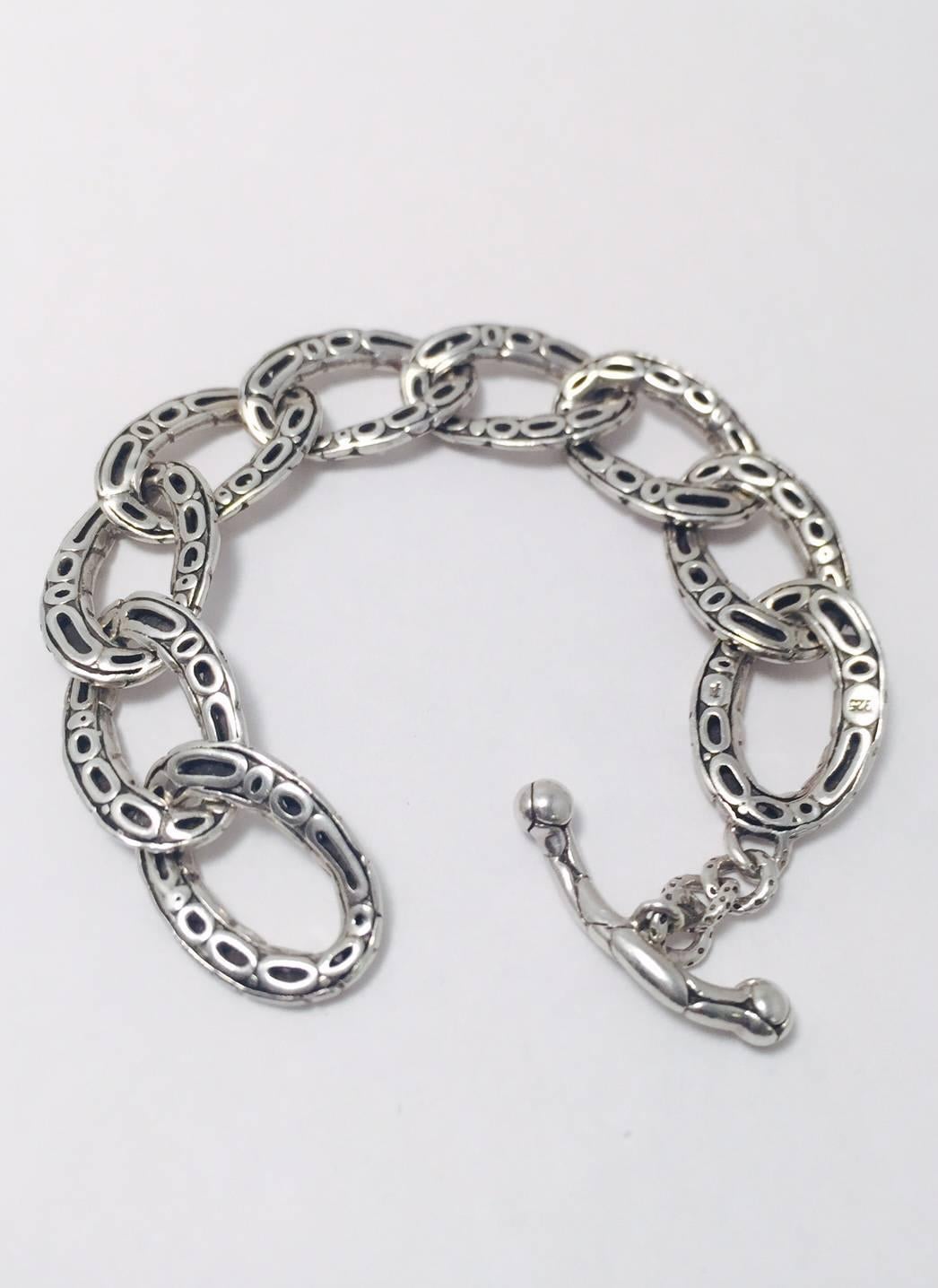 John Hardy works magic with Sterling Silver!  His pieces are highly collectible world wide.  This beautiful link bracelet, from his Kali collection, features nine interlocking links and an easy to handle toggle clasp.  Measures 7.25" long and