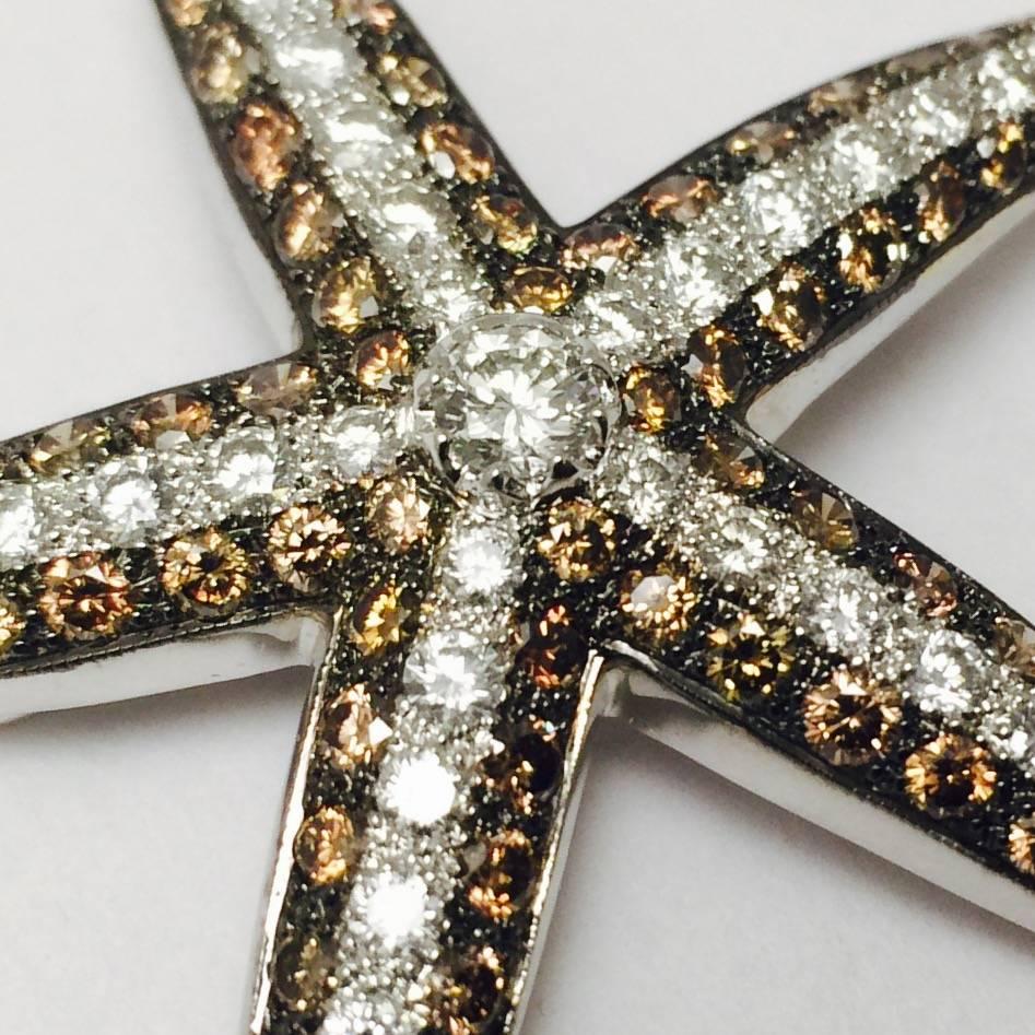 Originally sold in 1998 at Neiman Marcus for $18,000!
Meticulously crafted in 18 karat white gold, this starfish brooch is simply stunning and so very unusual.!
Edges are lined in perfectly matched, faceted round Champagne color diamonds.
Round,