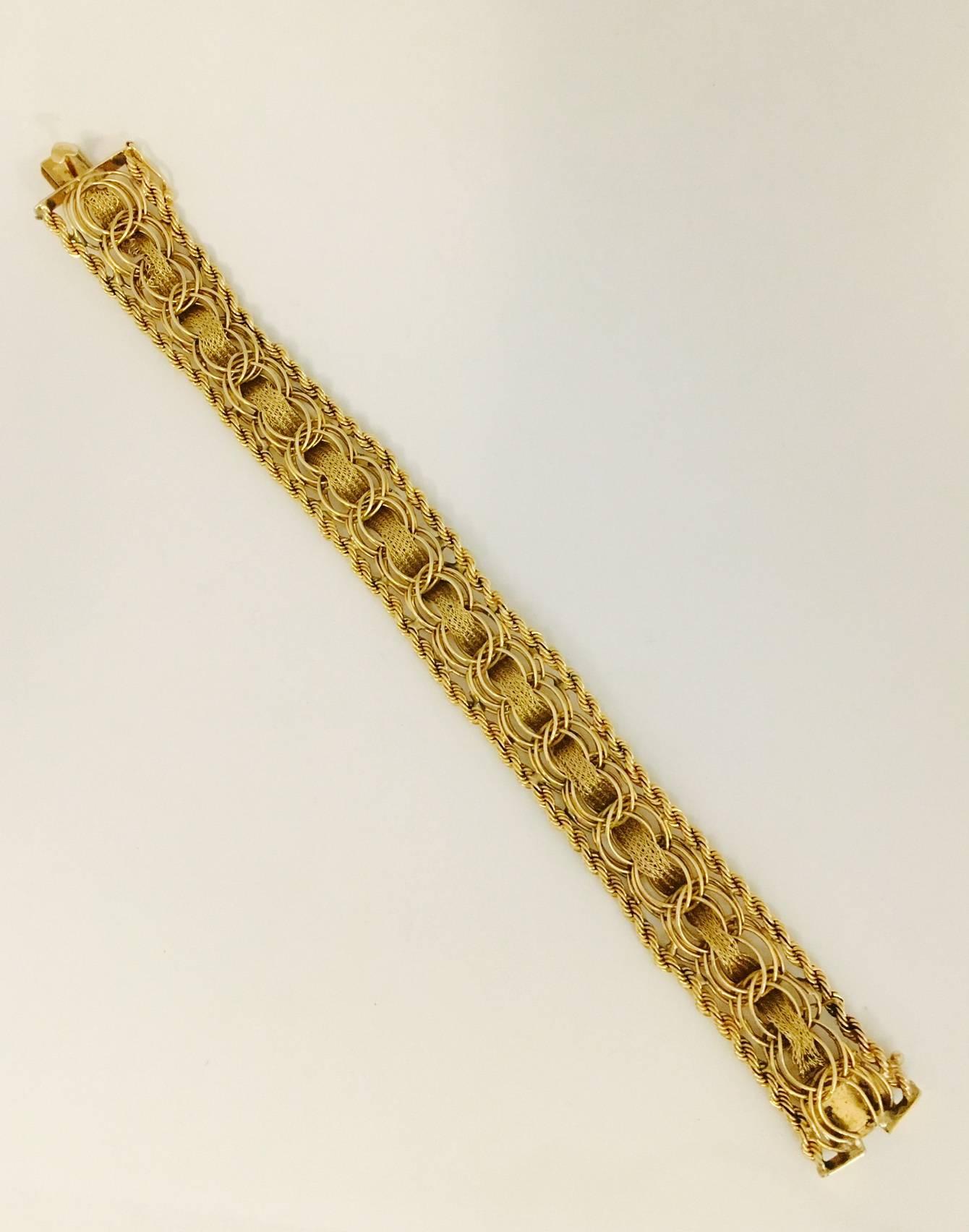 Charm bracelets have always been in style.  This beautiful 14 karat yellow charm bracelet can certainly be worn with or without charms.  Classic rope style border, with double spiral links (to affix charms) and curved rope stations intertwined. A