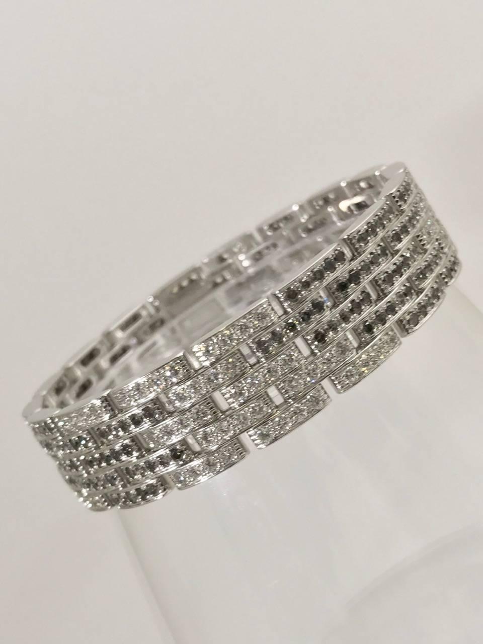 Rarely available with black and white diamonds, this Cartier Maillon Panthere bracelet is highly prized by connoisseurs of fine gems in general and Cartier in particular!  More commonly found with three rows, this 5 row stunner is instantly