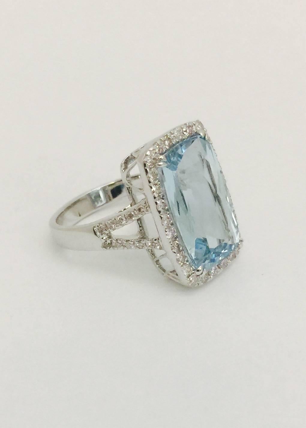 Aquamarine translates to "Water of The Sea".  This spectacular ring, crafted in 18 karat white gold boasts a stunningly clear and immaculately faceted emerald cut aquamarine weighing 7.19 carats.  Accented with white diamond micro pave