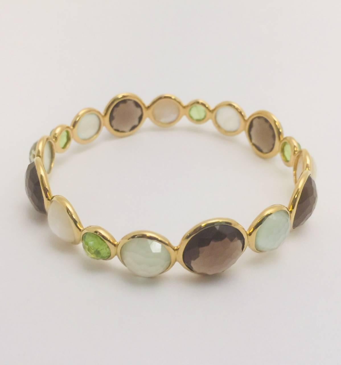 Ippolita Rostagno's Gelato collection captures the exuberance and joy of pairing semi-precious stones with ultra-luxurious 18K yellow gold!  The Hero Gelato Bangle features faceted mother of pearl and quartz doublets!  Additional quartz stations