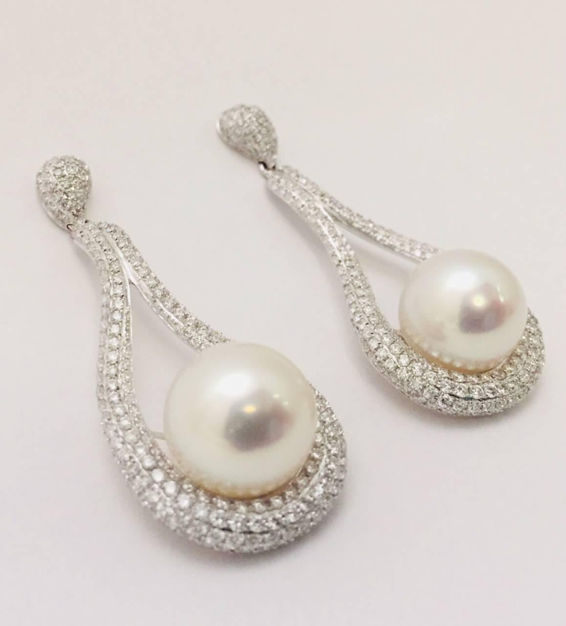 Gorgeous freeform drop earrings dazzle and mesmerize!  Crafted from 18K White gold, white pave-set diamonds and seductive 12mm South Sea pearls, these will quickly become a favored pair of pearls!  Perfect for special events, the upcoming holidays