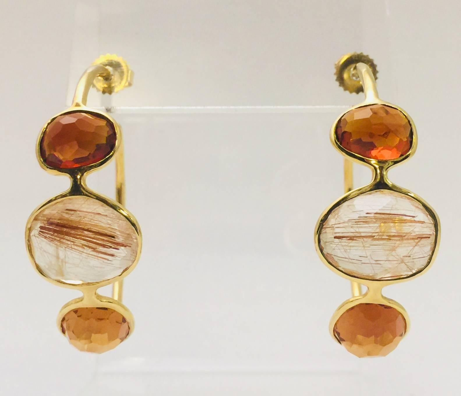 Rock Candy never looked so good!  Ippolita's signature rutilated stone jewelry has literally become a must for any up-and- coming fashionista or seasoned socialite!  These hoop earrings feature polished 18K yellow gold, faceted Quartz, and two