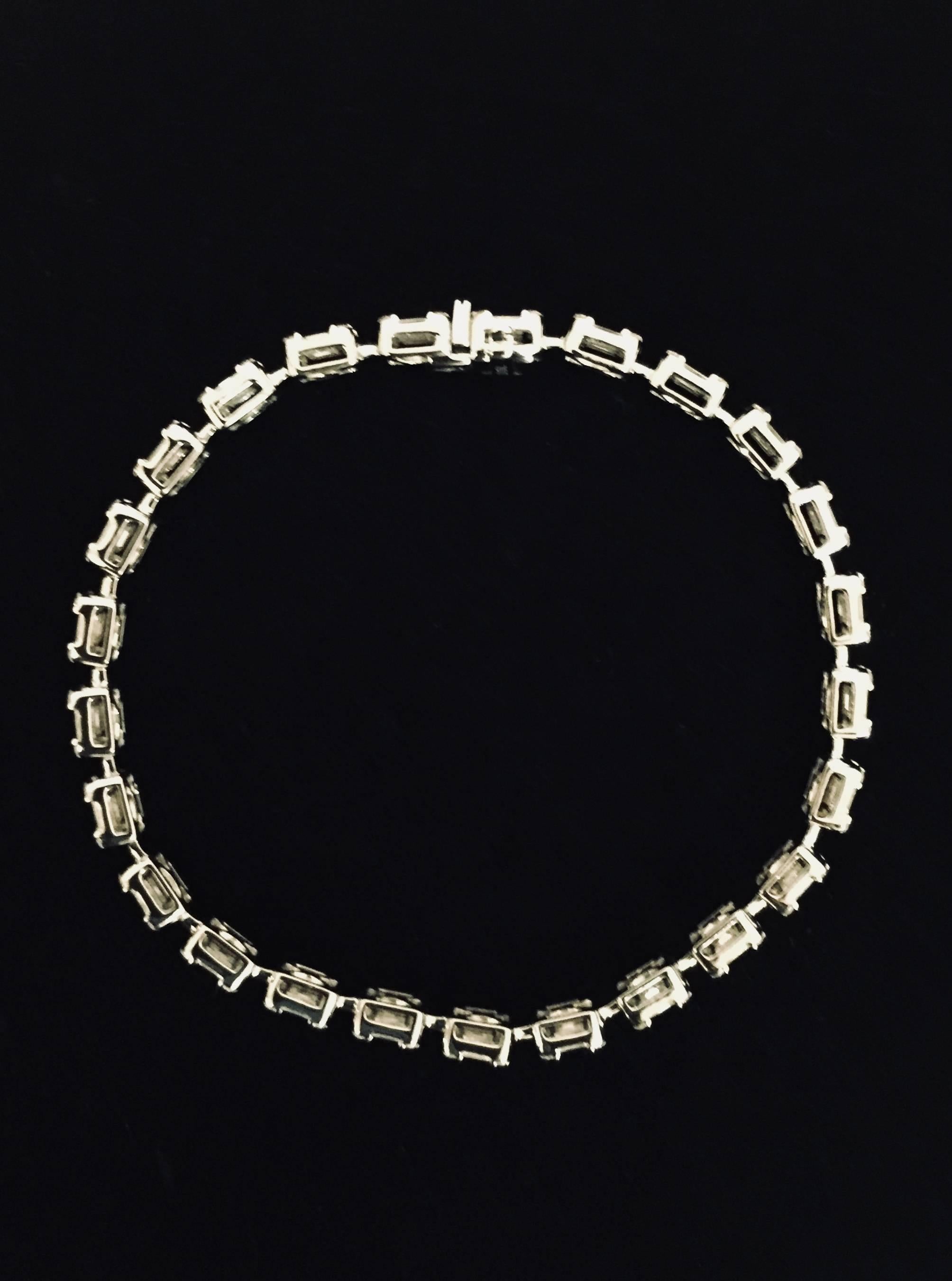 Brilliant design idea!  This inline 18 karat white gold bracelet features masterfully set round diamonds at the corners of baguette diamonds.  The effect created is an inline bracelet of all larger emerald cuts!  Absolutely can be worn daily! 