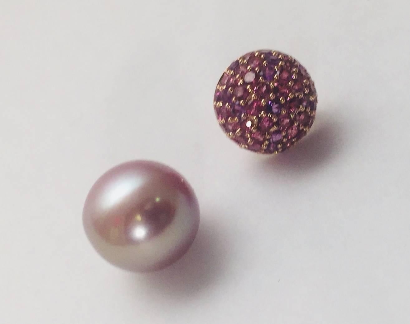 What a striking combination!  Beautifully crafted in 18 karat rose gold, these pierced earrings feature a button top replete with rhodolite garnets and amethysts having 2.80 carats total weight.  The colors are gorgeous together!  Under each button