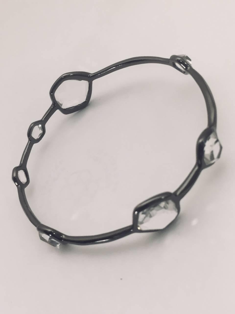 Ippolita is one of the most sought after designers today!  Young, fresh and contemporary styles!  This fabulous bangle bracelet features black rhodium sterling silver base with bezel set, different shape and size clear quartz stones referred to as