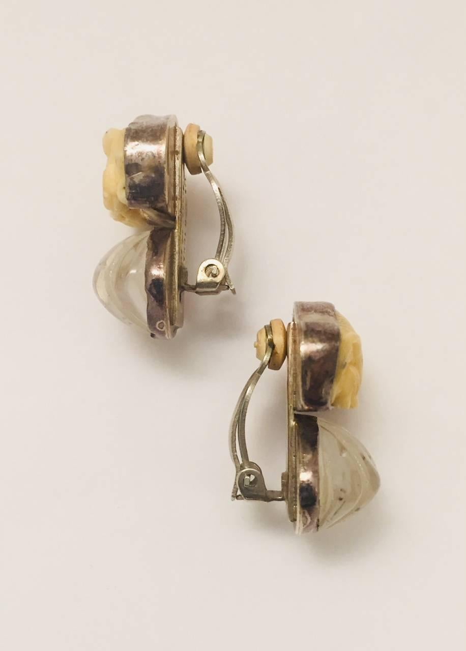 Rebecca Collins designs are highly collectible and oh, so unique! These hand crafted Sterling Silver clip earrings feature carved bone rabbits sitting atop fluted clear quartz.
The back of all of Rebecca's pieces are stamped with spiritual messages