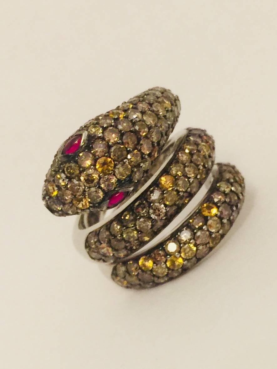 Contemporary 18 Karat Striking Snake Ring with Diamonds, Yellow Sapphires and Rubies For Sale