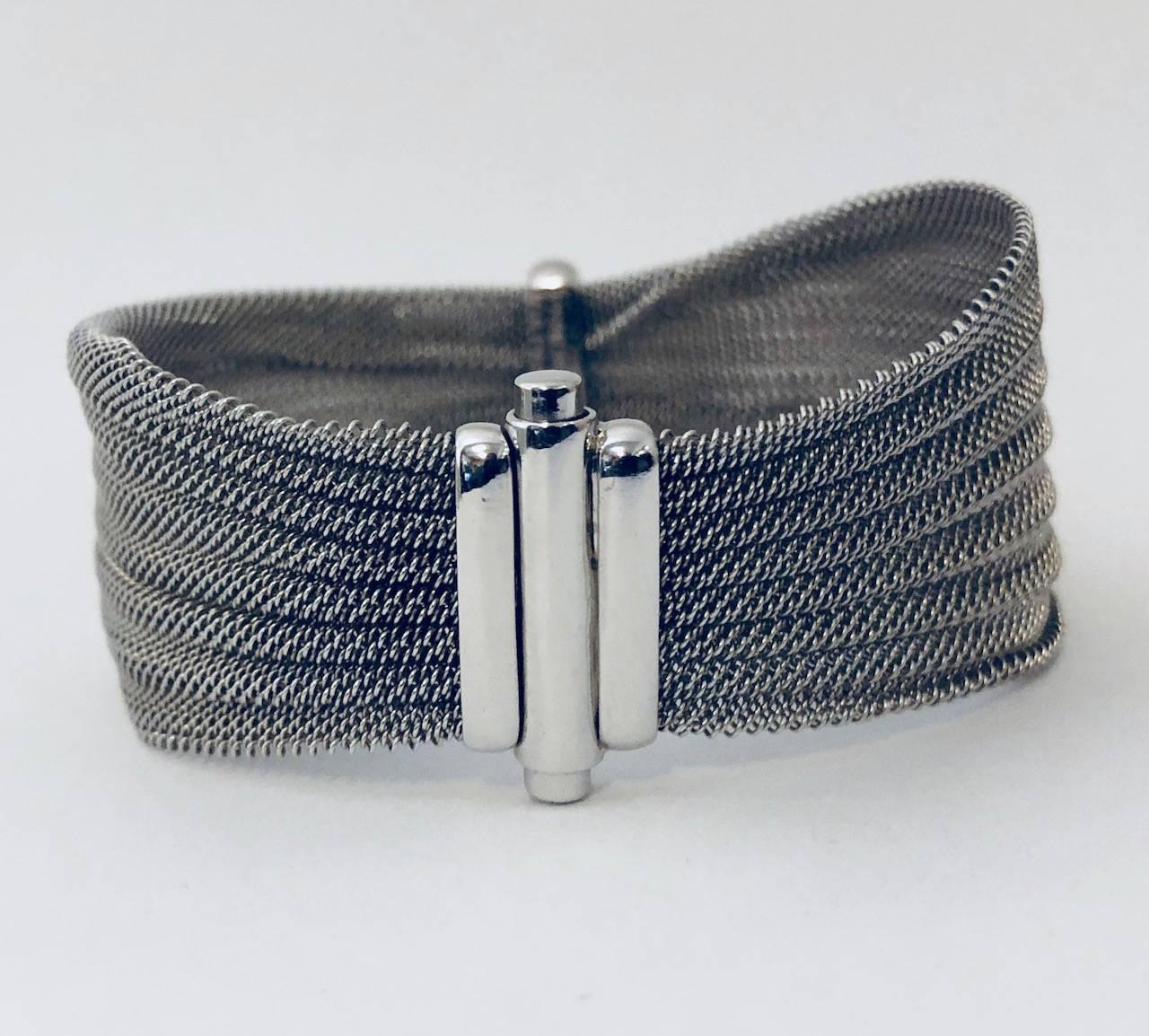 Panda fine jewelry is still marvelous for 2018!  This easy to wear anywhere 18 karat white gold mesh bracelet is a stunner!  Pinched in the center, it features a solid white pave diamond bar.  Approximately 1/2 carat total weight.  A double pronged