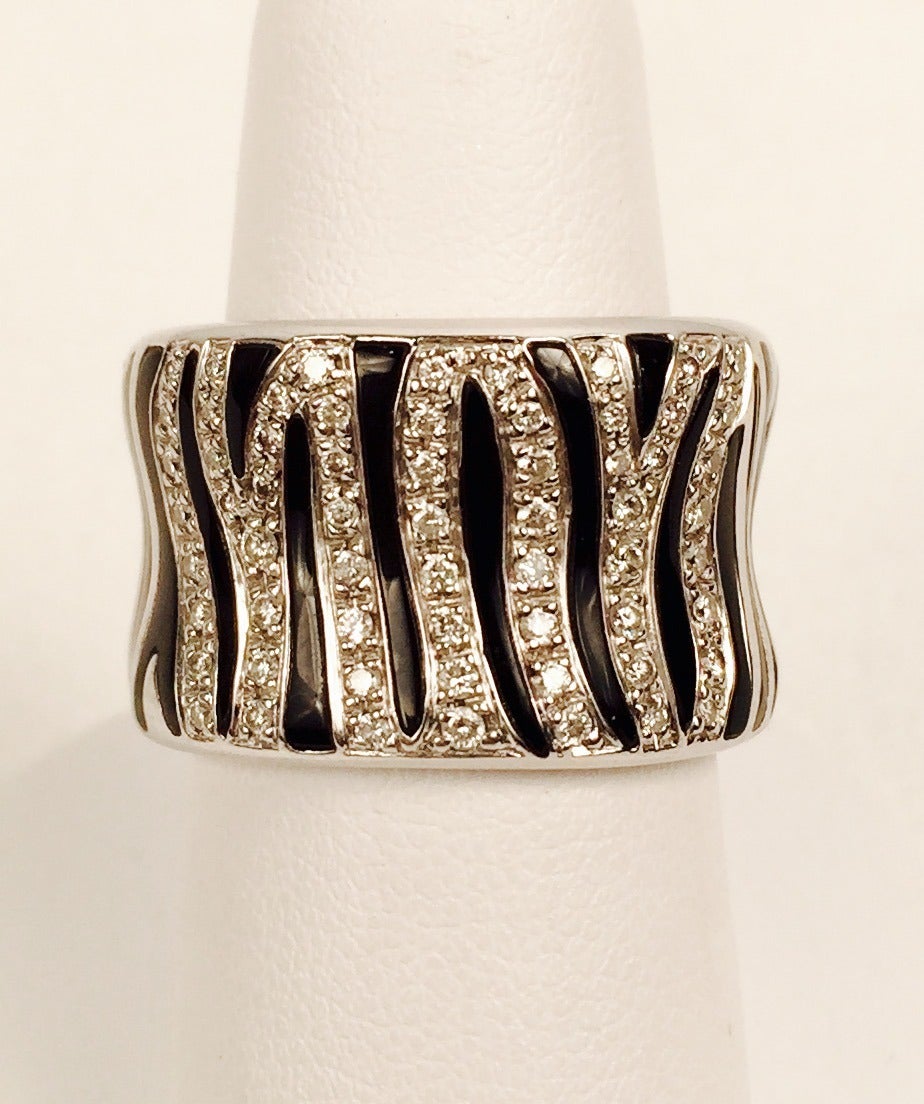 18K White Gold and black enamel from the distinct zebra pattern.
Seven brilliant cut diamond stripes make a magnificent accent.  Approximately .75 ct tw.  Wear with everything!  Size 7 1/2.  Diamonds G/H color, VS clarity.