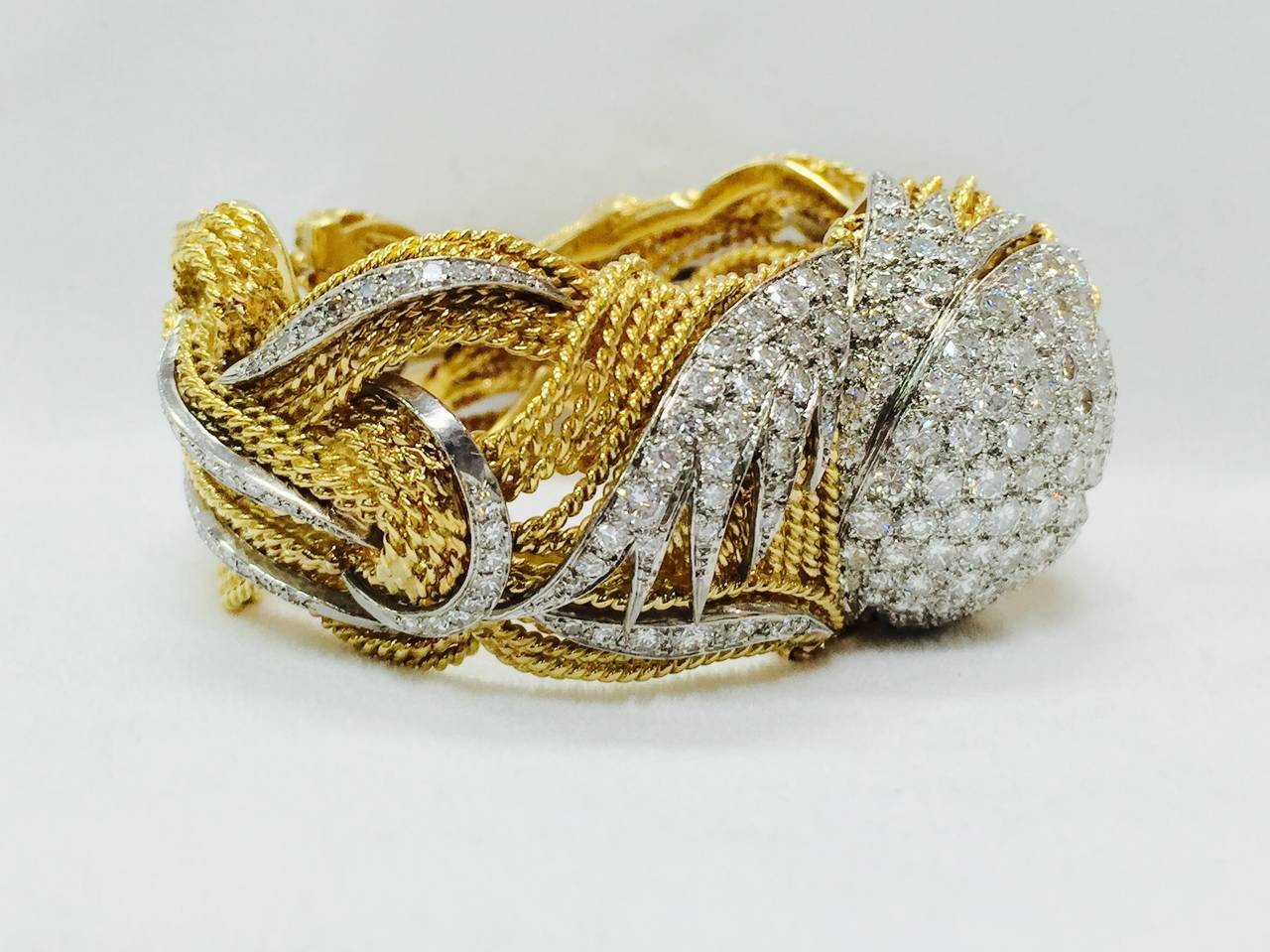 1970s Diamond and 18K Yellow Gold Bangle Bracelet is a delightful reminder of just how fabulous this era was! Meticulously crafted with rope wire and pointed end sections of brilliant cut and single cut diamonds in 18K White Gold.  Approximate total