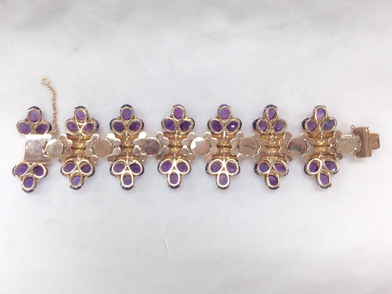 ONE OF A KIND!  This vintage piece is truly remarkable.  18K Rose Gold punctuated by 7 diamond cluster stations, and diamond bands in center of every link.  Perfectly matched cabochon amethysts appear joined together with diamonds.  Single and full