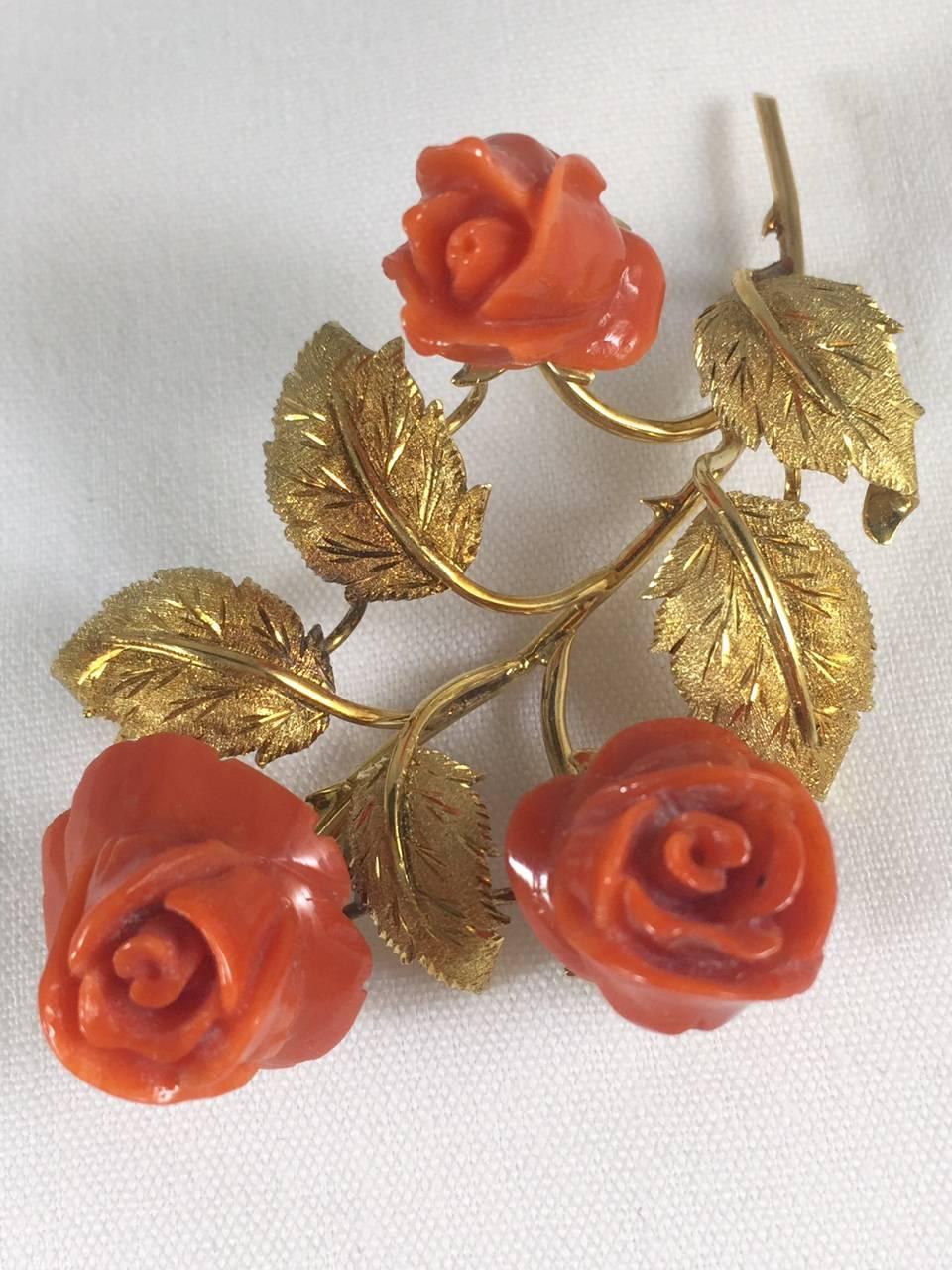 What could be more beautiful than hand carved Roses in natural red Mediterranean coral?  So lifelike they appear to bloom before your eyes!
Meticulously crafted in 18 karat yellow gold. A lifelike stem even has thorns and beautiful engraved,