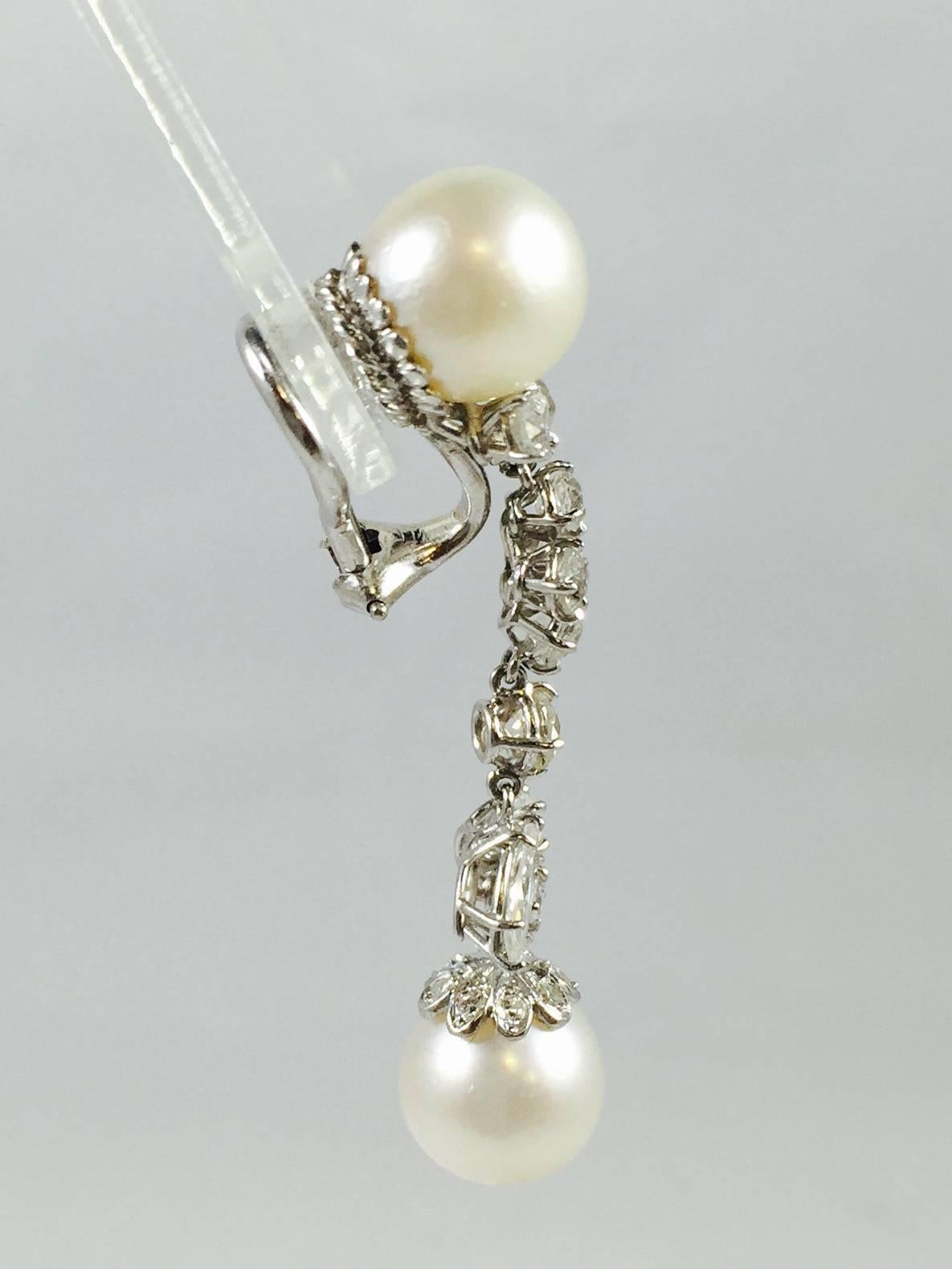 Perfection in Platinum!  A must have for any jewelry wardrobe!  Matched white lustrous beautifully end capped pearls stand between an artful drop of brilliant cut and marquise cut diamonds having an impressive 2.60 ct tw with F/G color, VS clarity. 