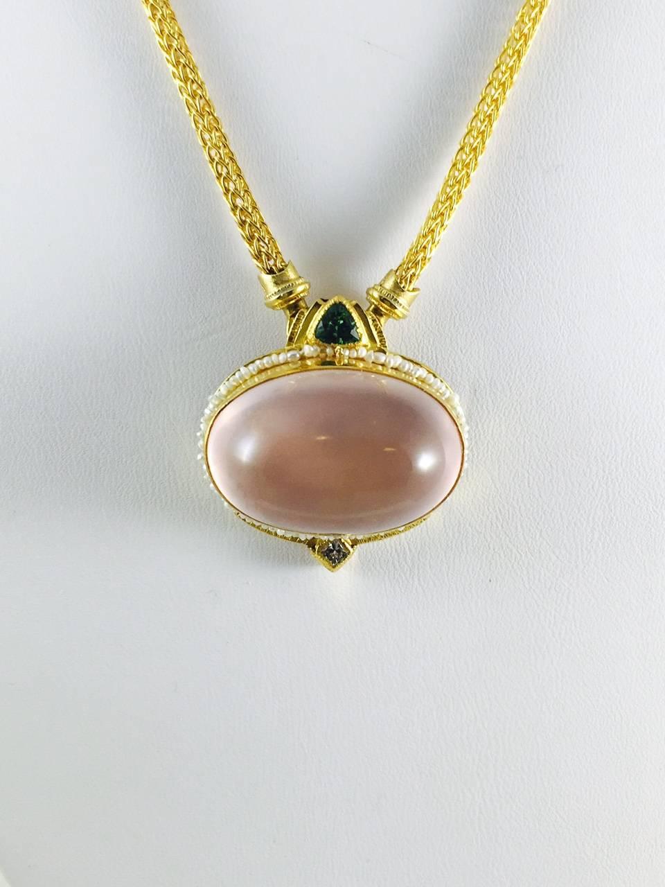 Unusual and stunning necklace!  22K yellow gold Wheat Chain holds a fabulous oval, bezel set, cabochon pink quartz surrounded by tiny seed pearls in a custom created 24K yellow gold frame.  Atop the frame sits a bezel set trillion green tourmaline. 