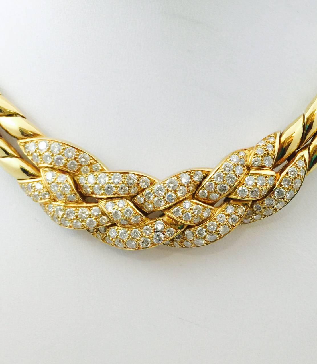From one of the most significant names in the jewelry business, this 18 karat yellow gold choker is beyond magnificent.  A double curved link chain comes together to support diamond pave links.  These links curve and appear to be intertwined. 