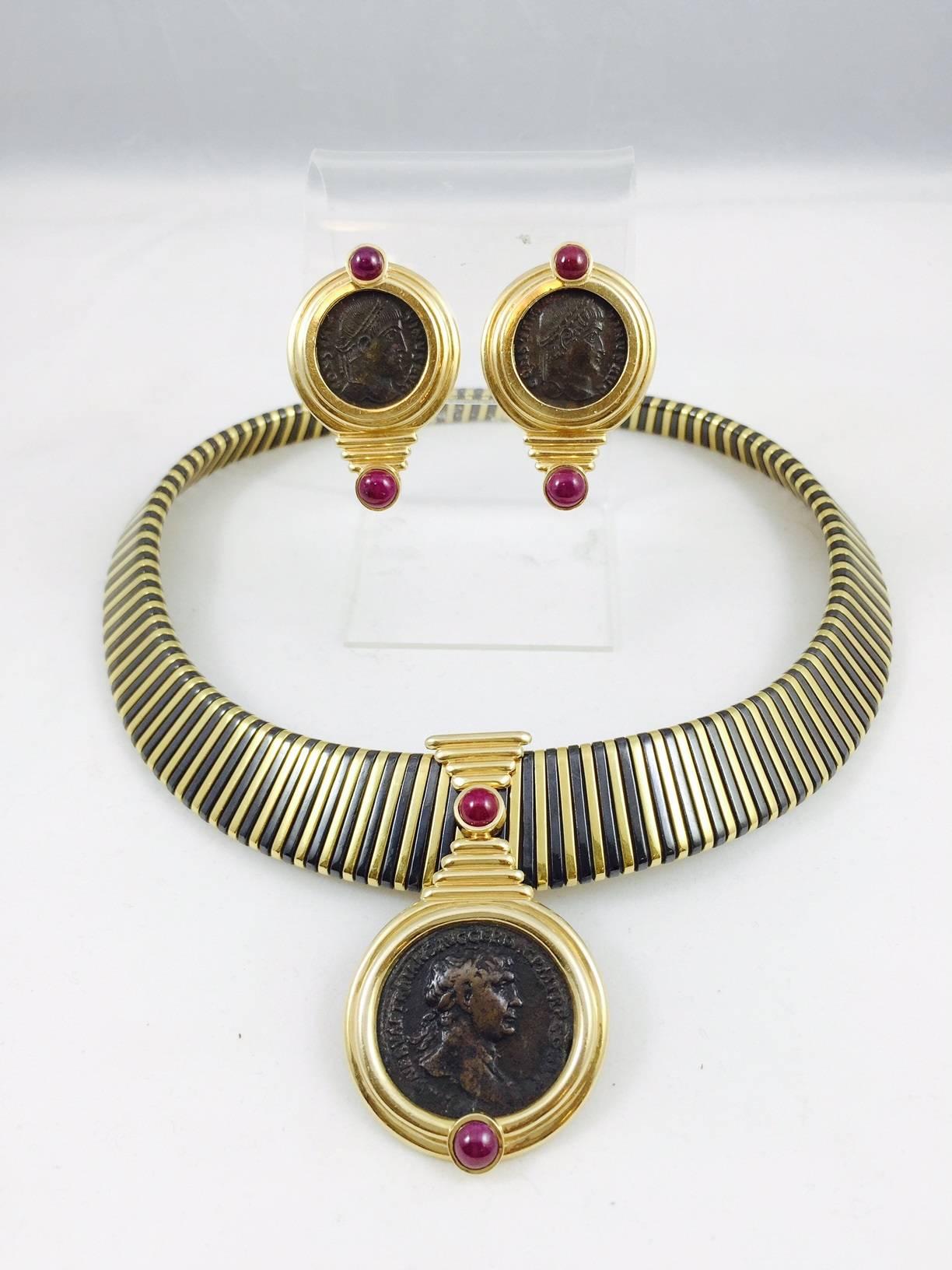 Let's begin by discussing this outstanding choker.  Classic tubogas design incorporating blackened steel between 18 karat yellow gold. A striking combination!  The antique Greek coin centered enhancer has a snap down clasp with figure 8 safety