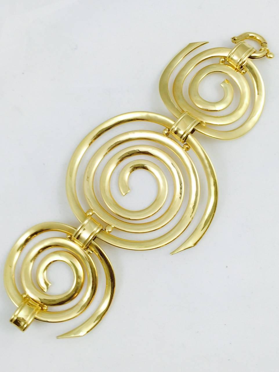 What a stunning bracelet!  Simple yet elegant.  High polished 18 karat yellow gold never goes out of style.  The gift of gold is always well received.  This bold design has 3 curved sections allowing the bracelet to embrace the wrist.  Wear it with