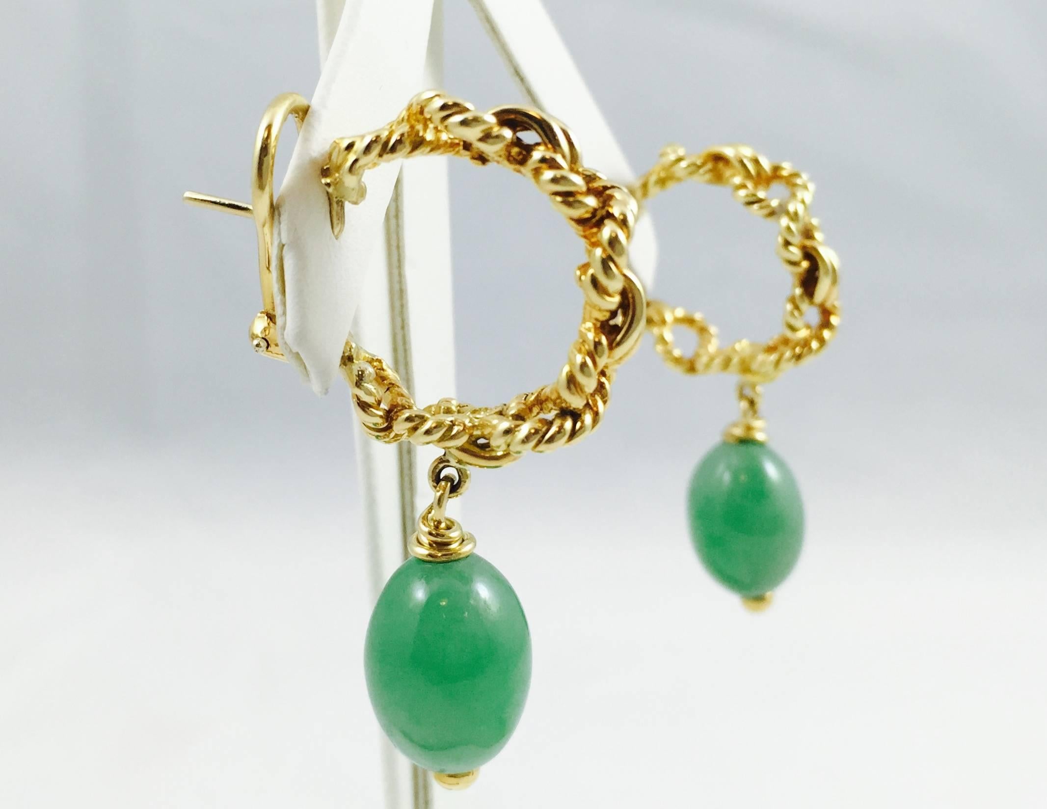 Tiffany & Co is perhaps the best known name in the jewelry industry.  These classic earrings are beautifully crafted in 18 karat yellow gold. Pierced Omega backs are easily converted to clip on style.  An open rope hoop boasts a serene green Jade