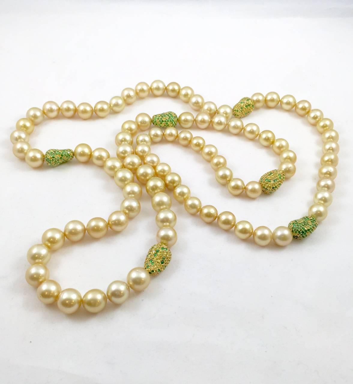 An important and most impressive addition to any fine jewelry collection.  Forty-two inches of magnificence!  Beautifully matched 9.5-10mm Golden South Sea Pearls are accentuated by six 18K yellow gold stations embellished with yellow sapphires and